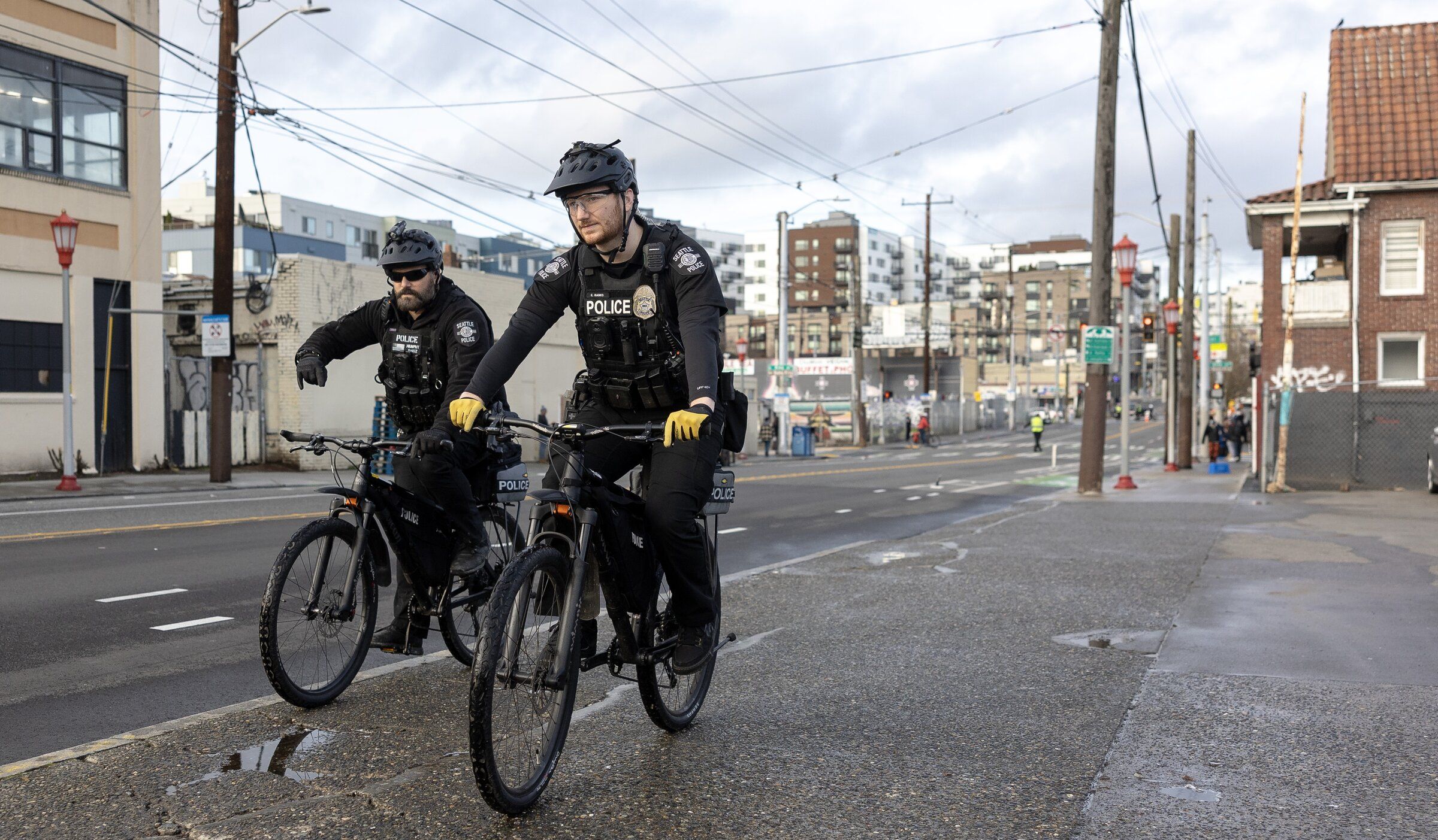 Seattle police officers patrol South 12th Avenue in December 2024. (Nick Wagner / The Seattle Times)