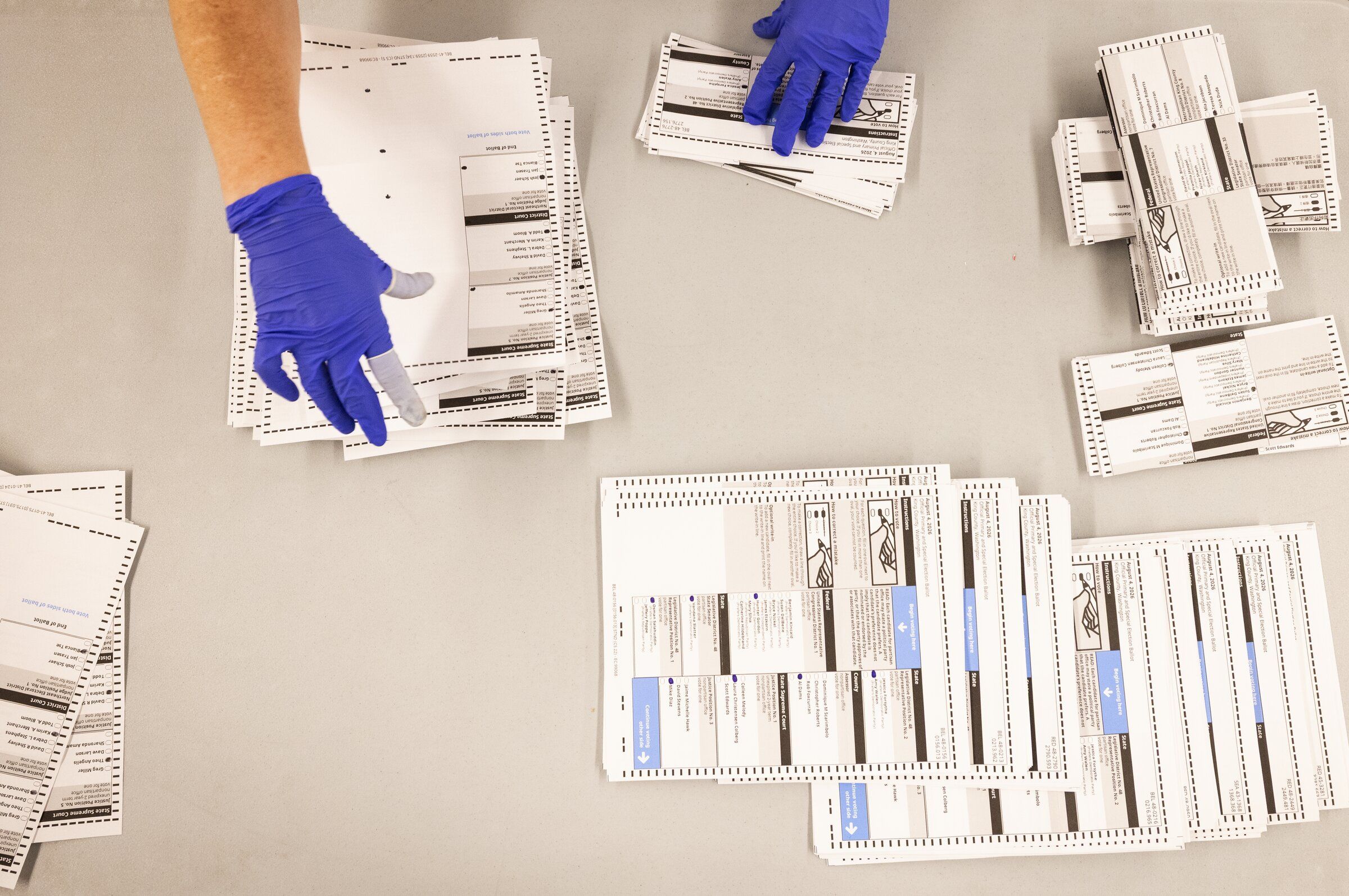 In a “democracy checkup” after the Supreme Court upheld mail-in balloting, election experts say the real constitutional crisis may come after the voting is over. Here, primary ballots are counted in Renton in August. (Ken Lambert / The Seattle Times)
