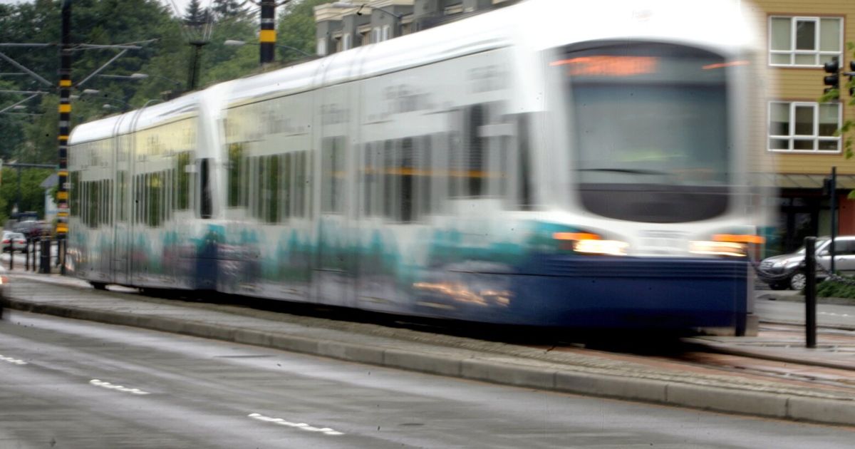 Seattle light rail train and empty school bus collide