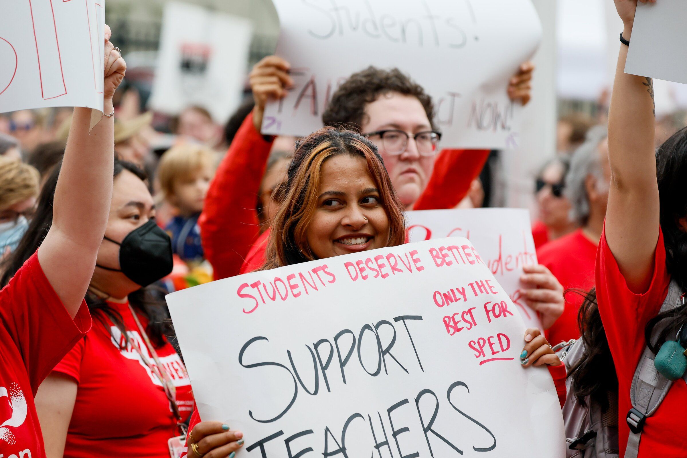 Roshni Sinha holds up a sign in support of teachers during a Seattle Education Association rally outside the Seattle Public Schools headquarters on Tuesday, Sept. 1. (Jennifer Buchanan / The Seattle Times)