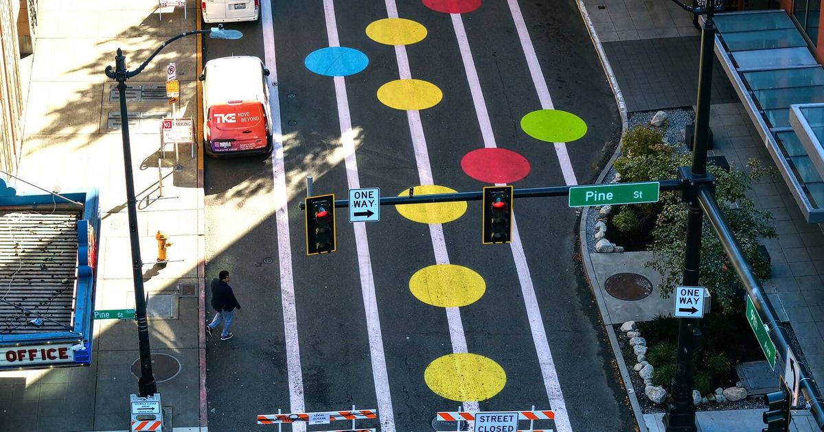 Colorful art won’t come off a Seattle street, so dull paint will cover it