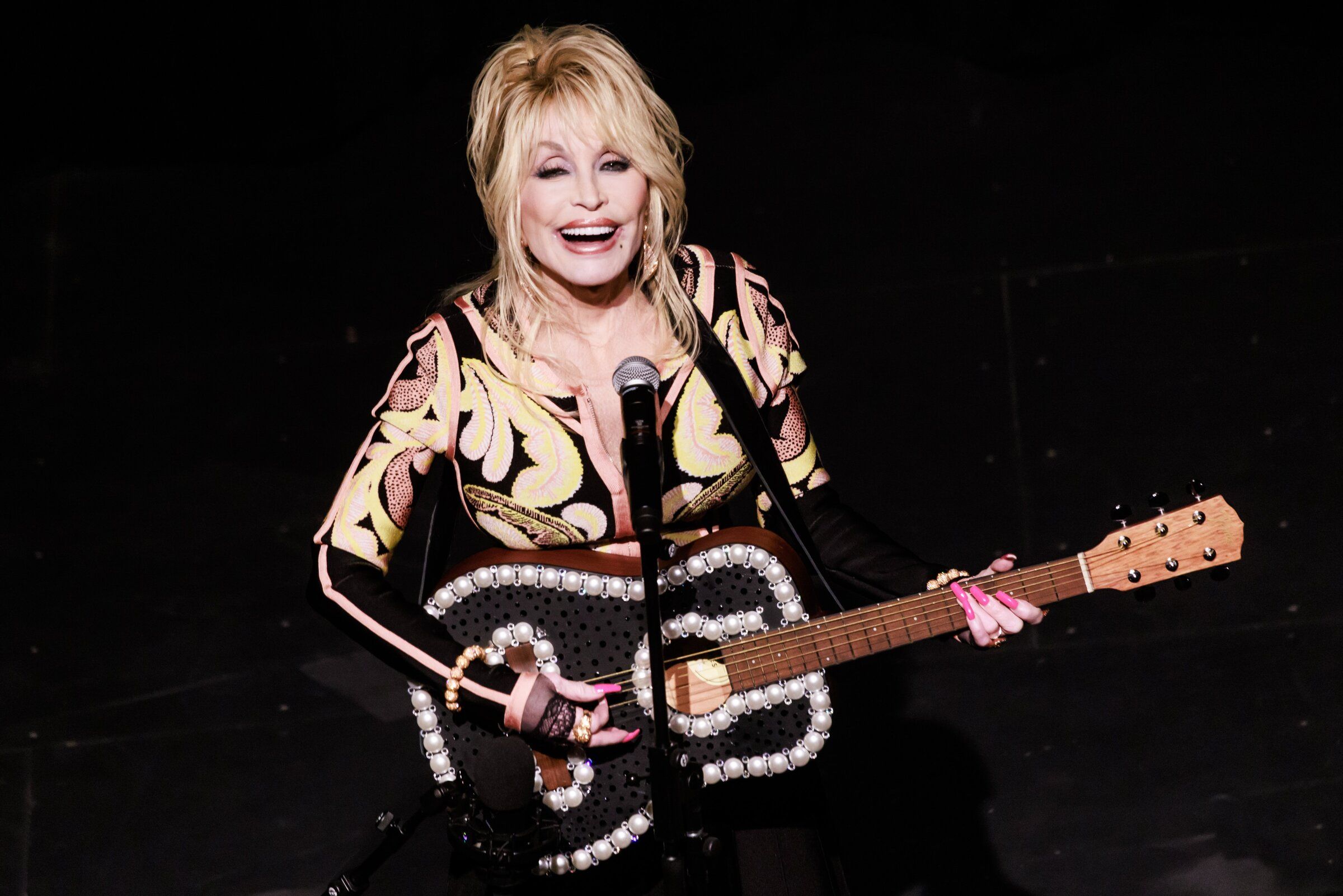 Dolly Parton performs at a celebration for the Imagination Library at the Pantages Theater in Tacoma in 2023. (Erika Schultz / The Seattle Times)