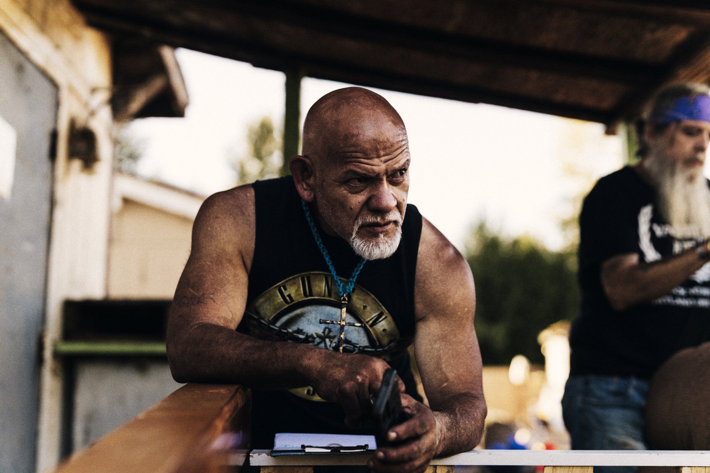 A resident at a council meeting in Dignity Village, a community of about 60 people living in hand-built tiny homes on the site, Portland, Oregon, Aug. 12, 2026. (Ricardo Nagaoka/The New York Times)