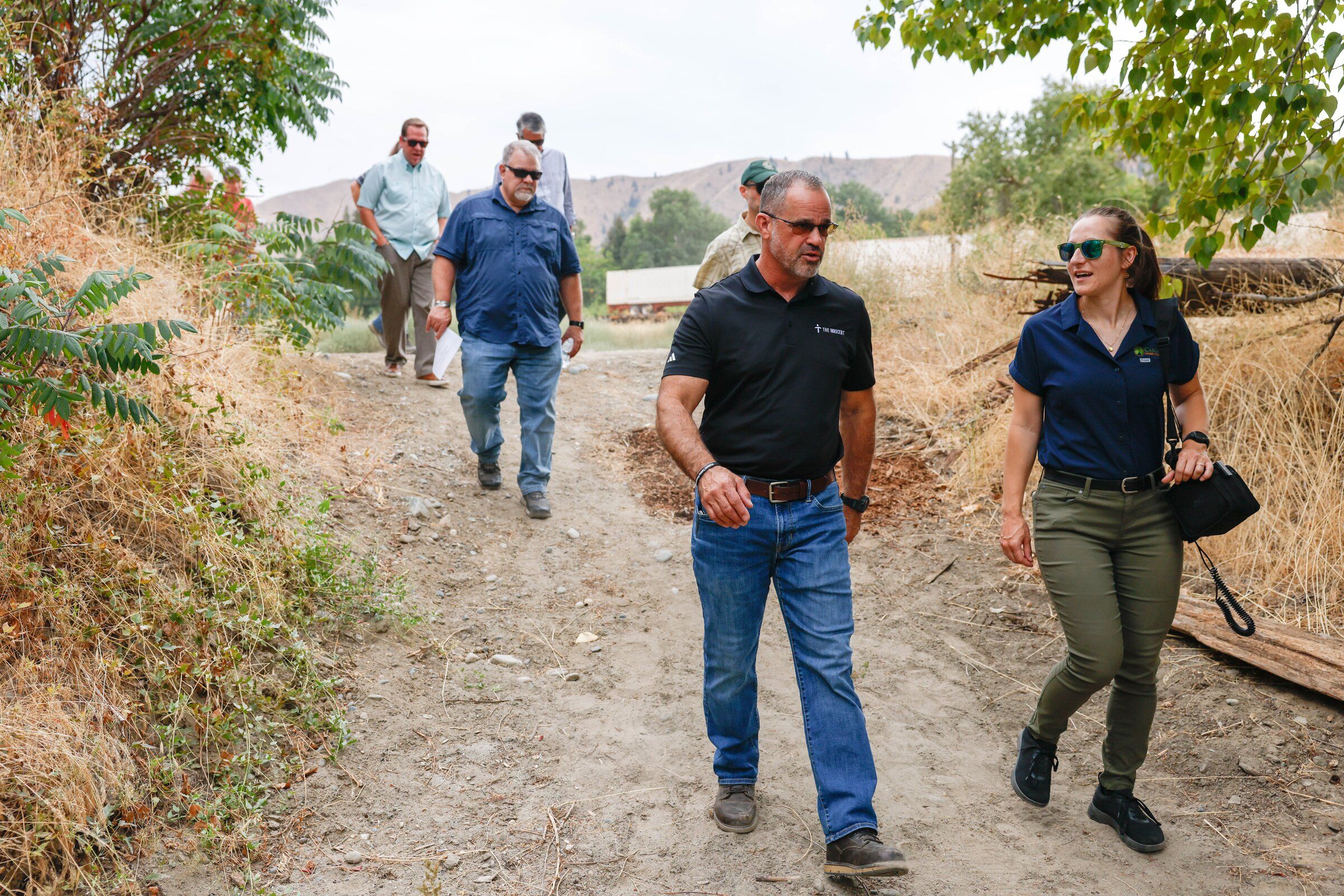 State Rep. Brian Burnett talks with Marcy Bartelheimer, an agricultural resources specialist from the Cascadia Conservation District, during an inspection of the irrigation system near the Wenatchee River in Cashmere. (Andrew Burke-Stevenson / The Seattle Times)