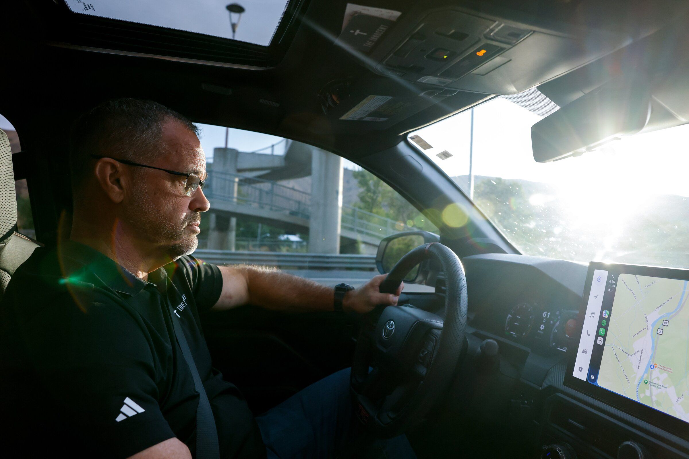 State Rep. Brian Burnett rides from a tour of the new YMCA facility in Wenatchee to the Chelan County Fair in Cashmere. (Andrew Burke-Stevenson / The Seattle Times)