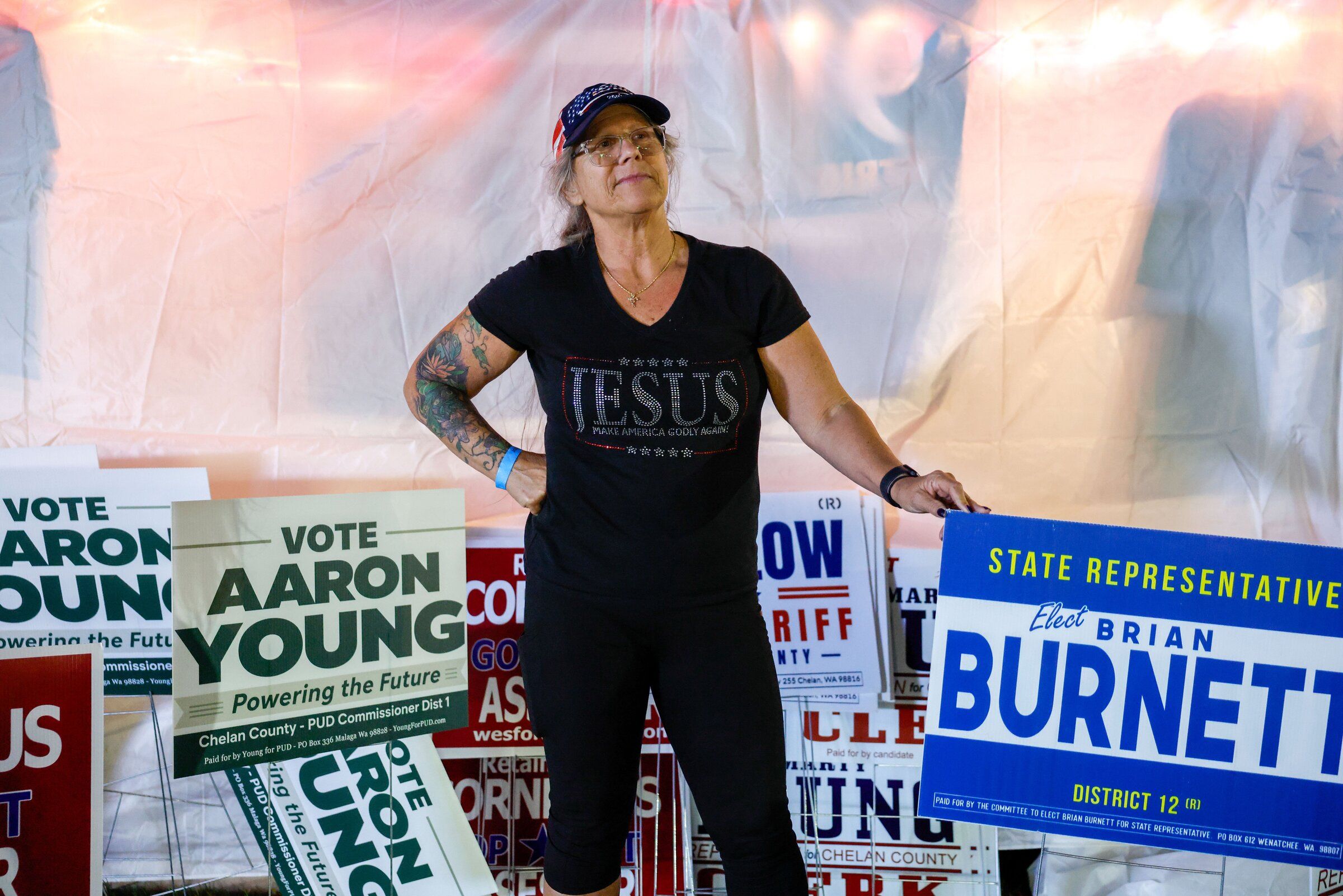 Donna Brady, a supporter of state Rep. Brian Burnett, prepared Republican campaign signs for visitors to the Chelan County Fair in Cashmere last month. (Andrew Burke-Stevenson / The Seattle Times)
