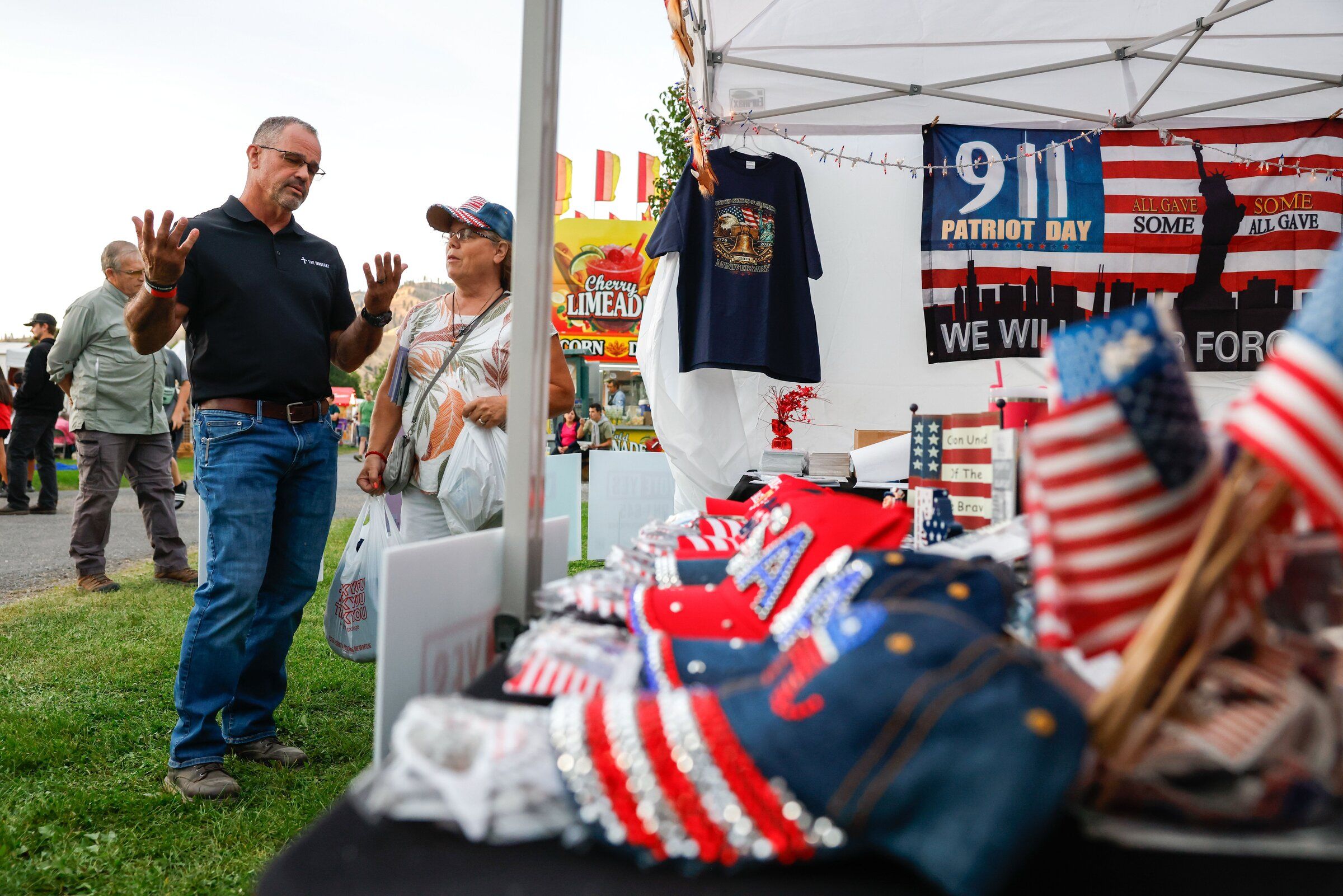 At the Chelan County Fair in Cashmere, state Rep. Brian Burnett meets with a voter at a Republican Party booth. (Andrew Burke-Stevenson / The Seattle Times)