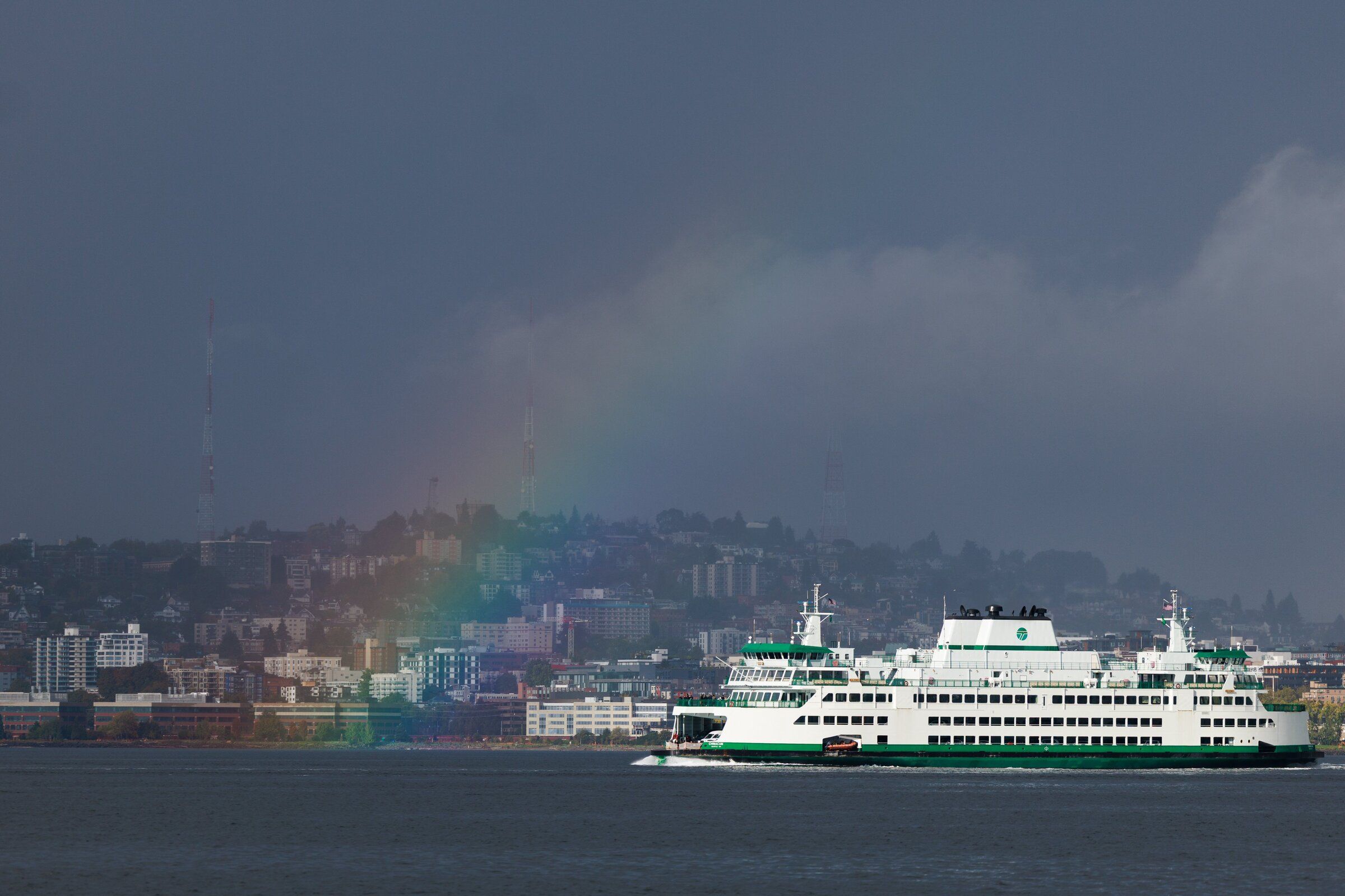 After a rainstorm, a rainbow appears as ferry travels on Elliott Bay in Seattle on Friday. 
(Erika Schultz / The Seattle Times)