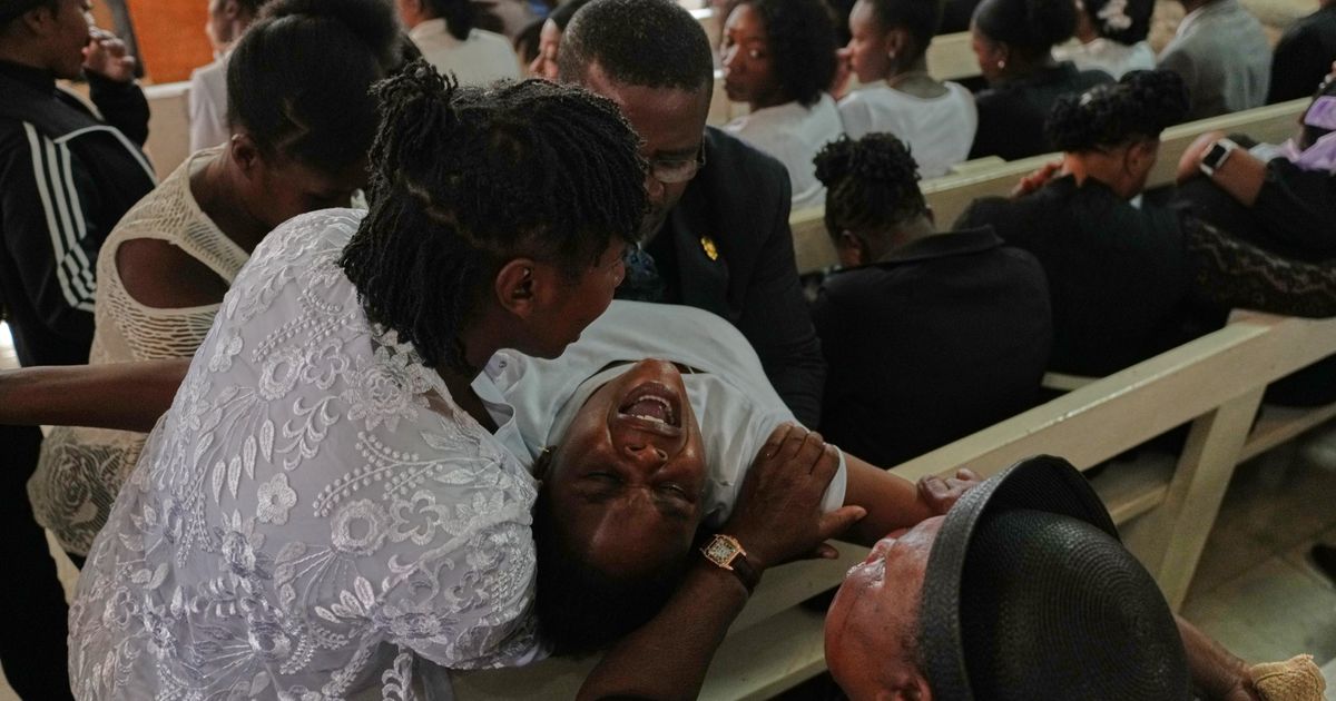 Mourners file into a church in Haiti where gangs killed dozens of people in latest rampage