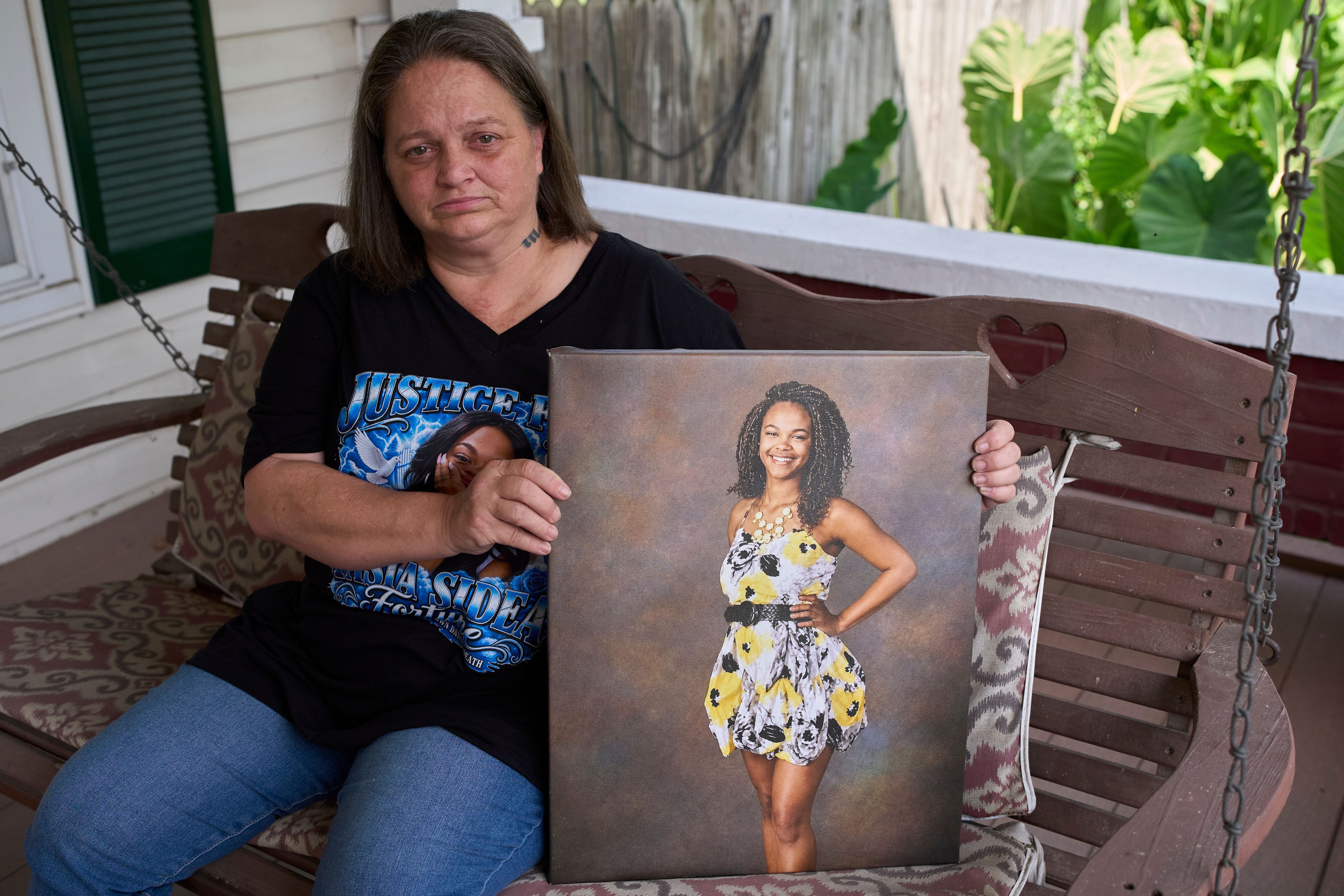 Kristi Spivey poses with a portrait of her late daughter, Tasia Fortune, Tuesday in Marion, Kentucky. (George Walker IV / The Associated Press)