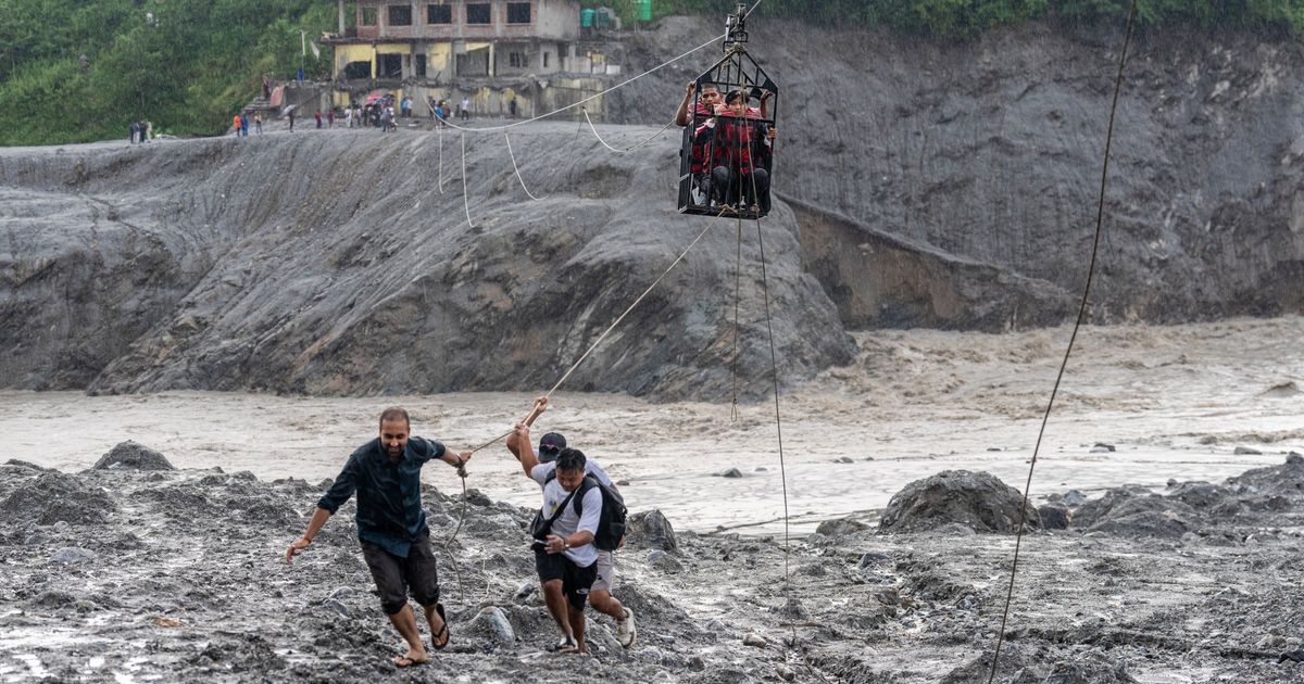Trading food for medicine and crossing the river by zip line are part of life in Nepal flood zone