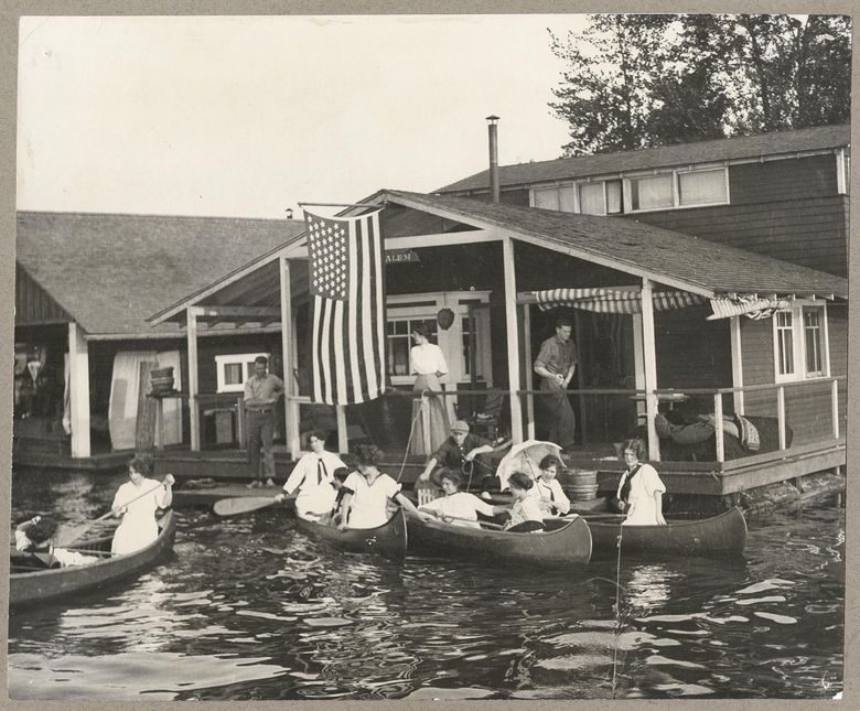 Canoes gather at a floating home on Lake Washington in 1912. As regulations and location restrictions increased over the years, the number of floating homes in Settle dropped from as many as 3,000 homes to fewer than 1,000. Today, there are no floating homes on Lake Washington. (MOHAI, SHS9025)