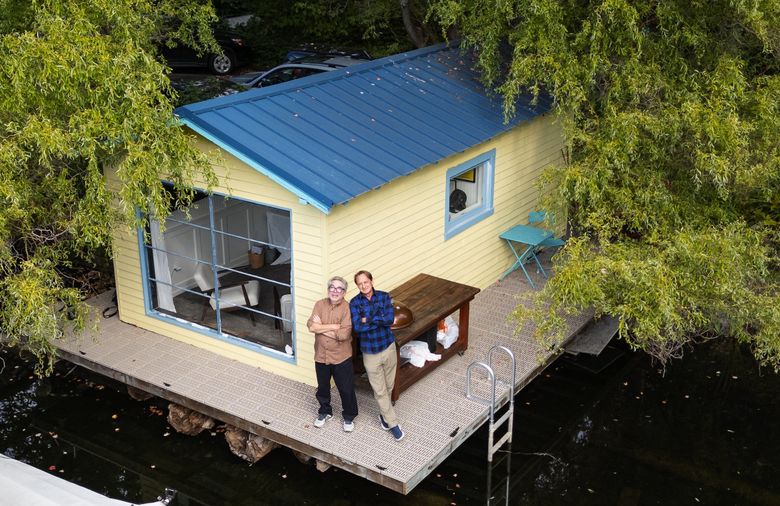Adam Woog, left, the Floating Homes Association’s resident historian and Stafford Green, the group’s president, meet at Keasler Cottage. Both Woog and Green live on floating homes. (Ken Lambert / The Seattle Times)