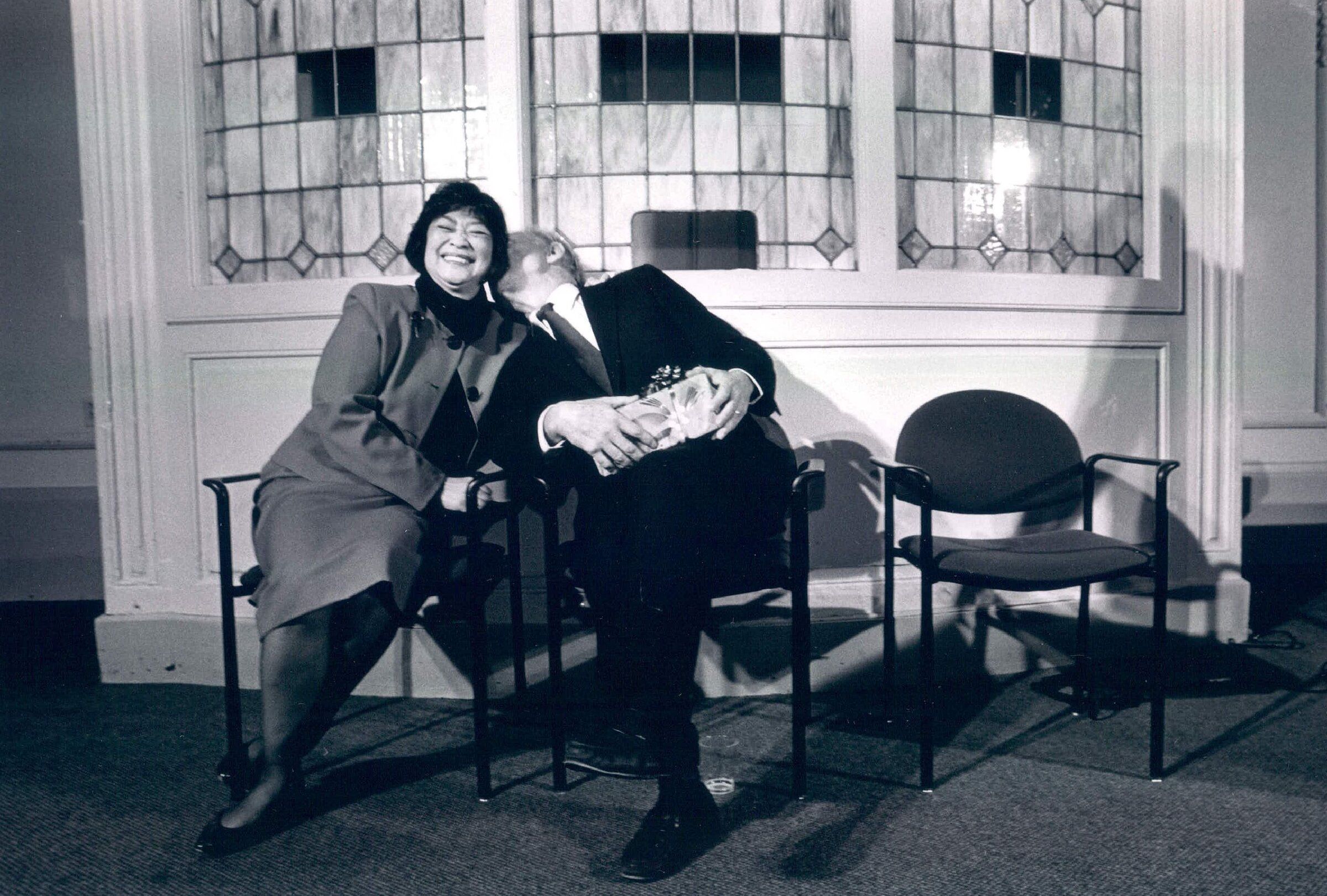 Dolores Sibonga gets a friendly peck on the cheek from fellow City Council member Paul Kraabel. (Rod Mar / Seattle Times, 1991)