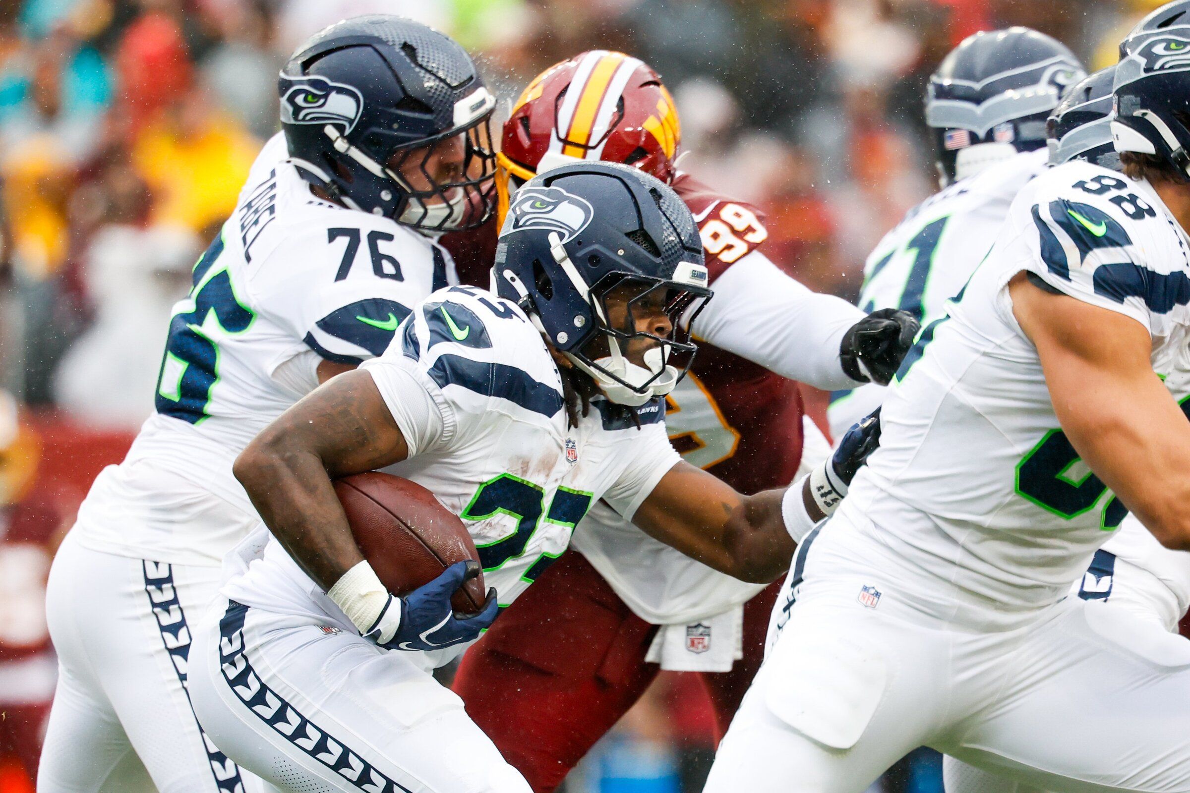 Seattle Seahawks running back Emanuel Wilson runs into traffic while rushing the ball against the Washington Commanders, Sept. 27, 2026, in Landover, Md. (Jennifer Buchanan / The Seattle Times)