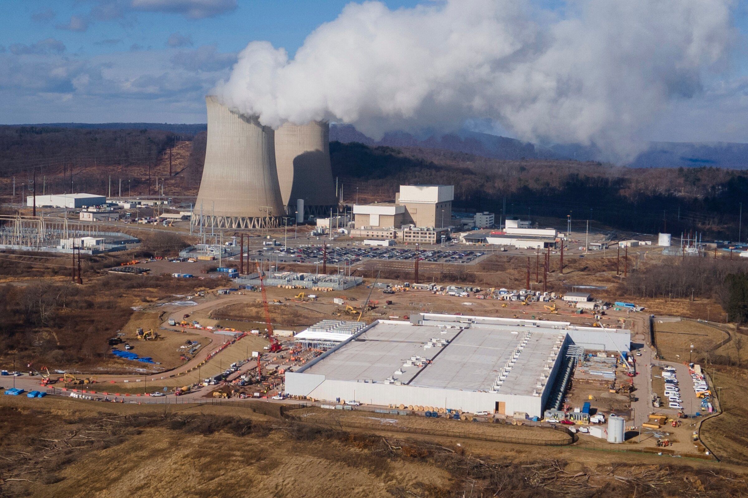 A data center owned by Amazon Web Services, front right, is under construction next to the Susquehanna nuclear power plant in Berwick, Pa. (Ted Shaffrey / The Associated Press, 2025)