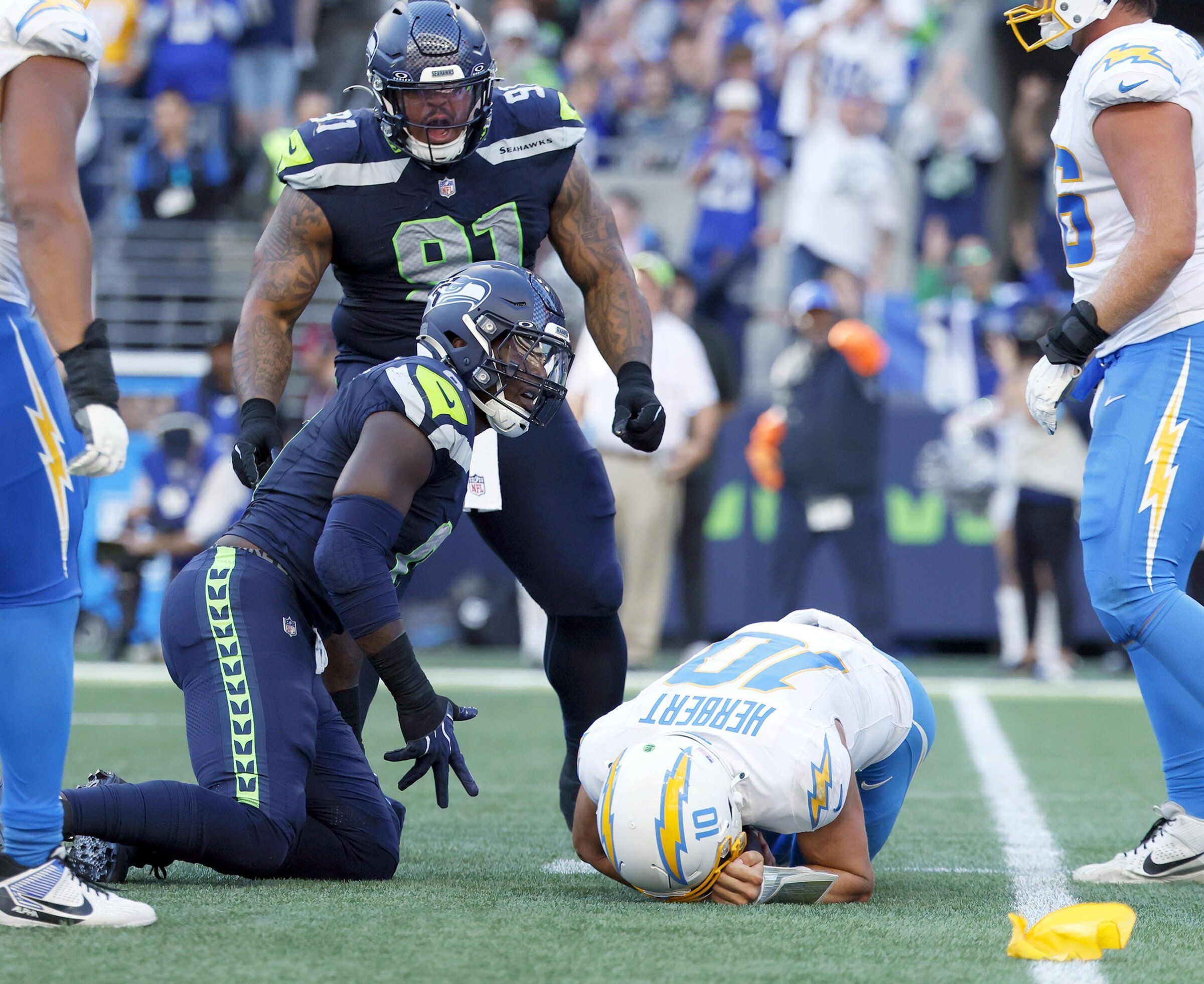 Seattle Seahawks defensive tackle Byron Murphy II (91) looks on as teammate DeMarcus Lawrence (0) commits a personal foul in the fourth quarter Sunday, Oct. 4, 2026 in Seattle. (Jennifer Buchanan / The Seattle Times)