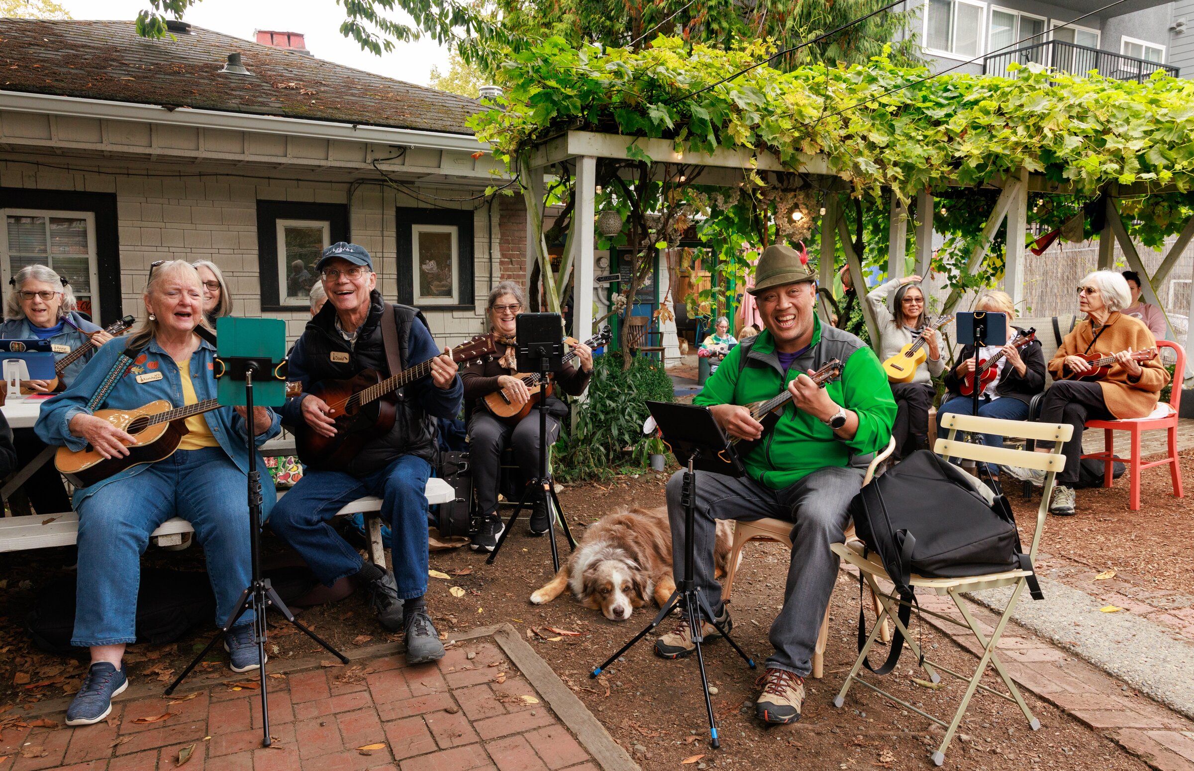 Raymond Sismaet, wearing green, plays with the West Seattle Ukulele Players at C&P Coffee Company in West Seattle on Thursday. (Erika Schultz / The Seattle Times)