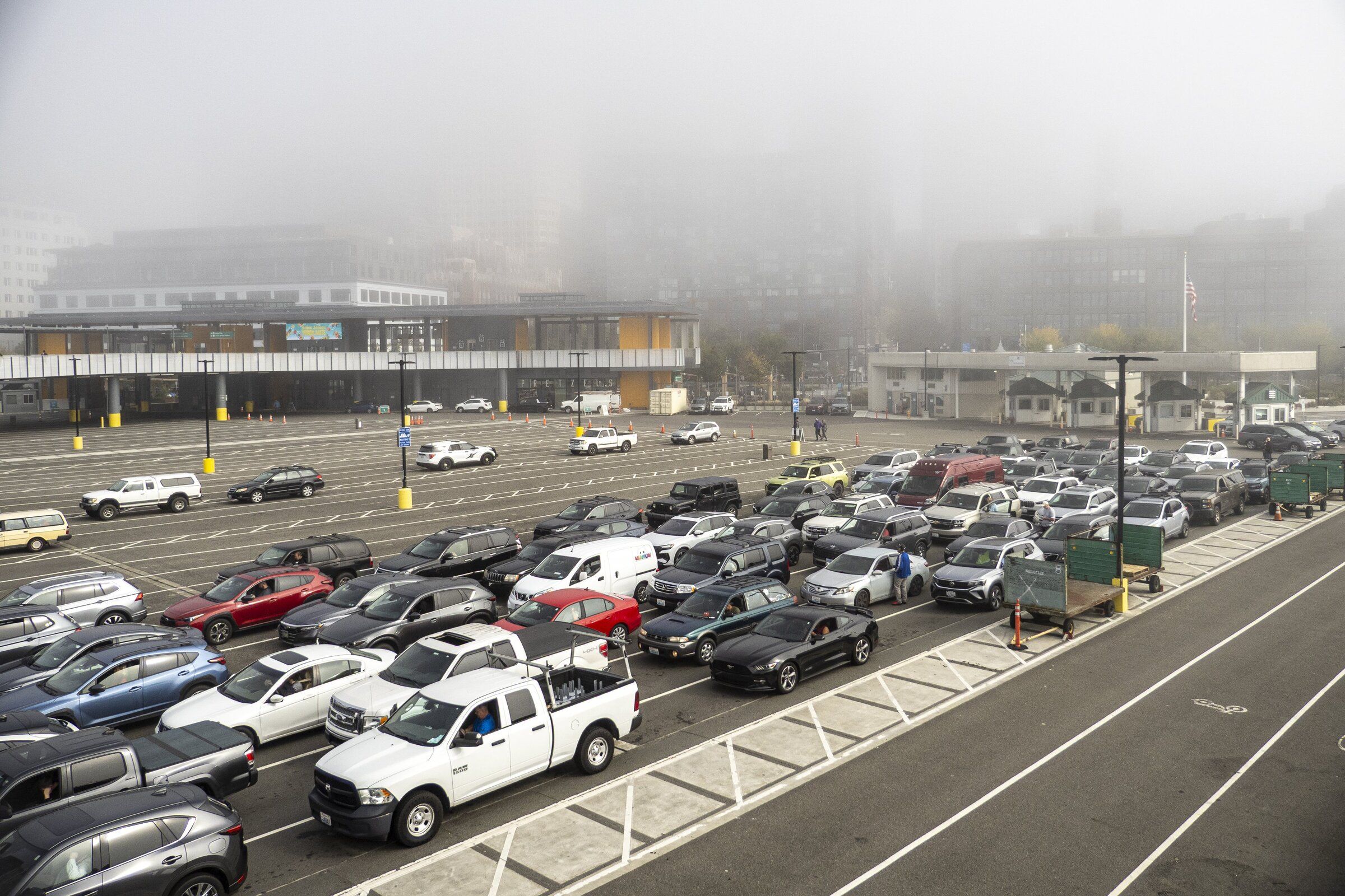 Passengers await a Bremerton-bound ferry Monday morning at Washington State Ferries’ Seattle terminal at Colman Dock on Oct. 5, 2026. (Kevin Clark / The Seattle Times)
