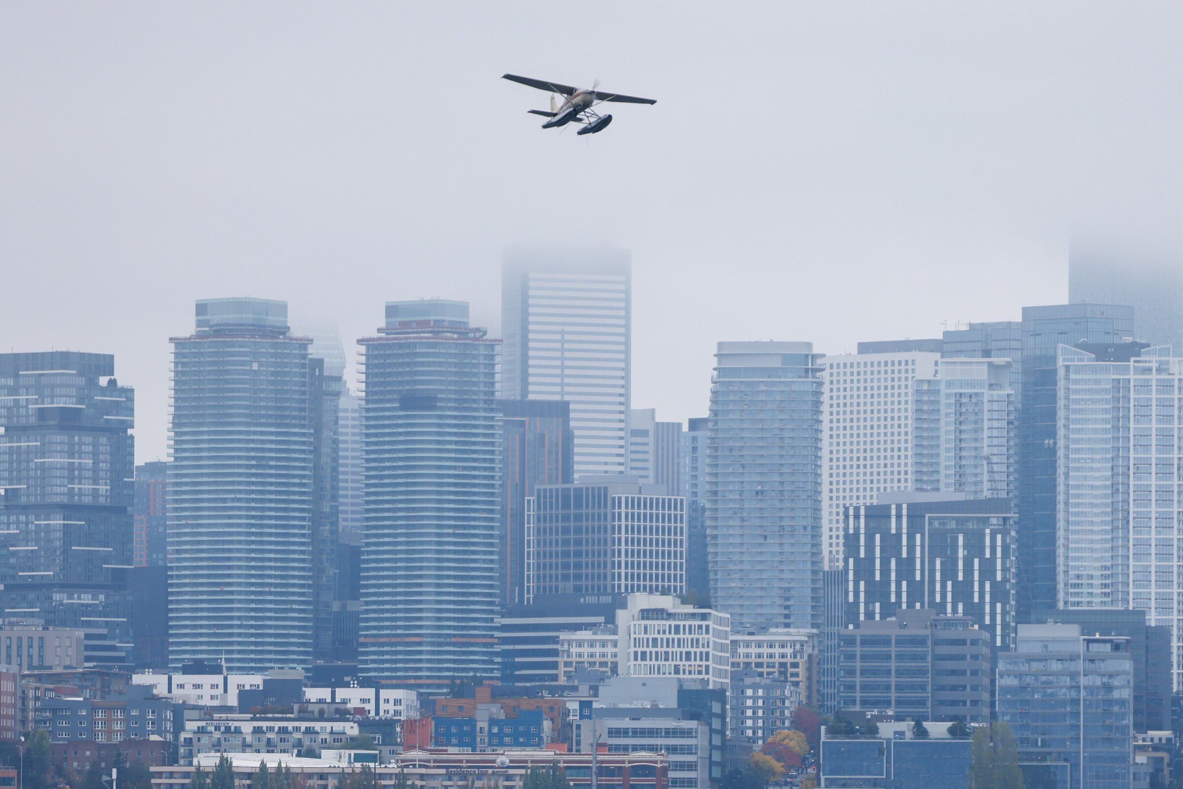 A seaplane flies over Lake Union, with the Seattle skyline as a backdrop, on Saturday. (Andrew Burke-Stevenson / The Seattle Times)
