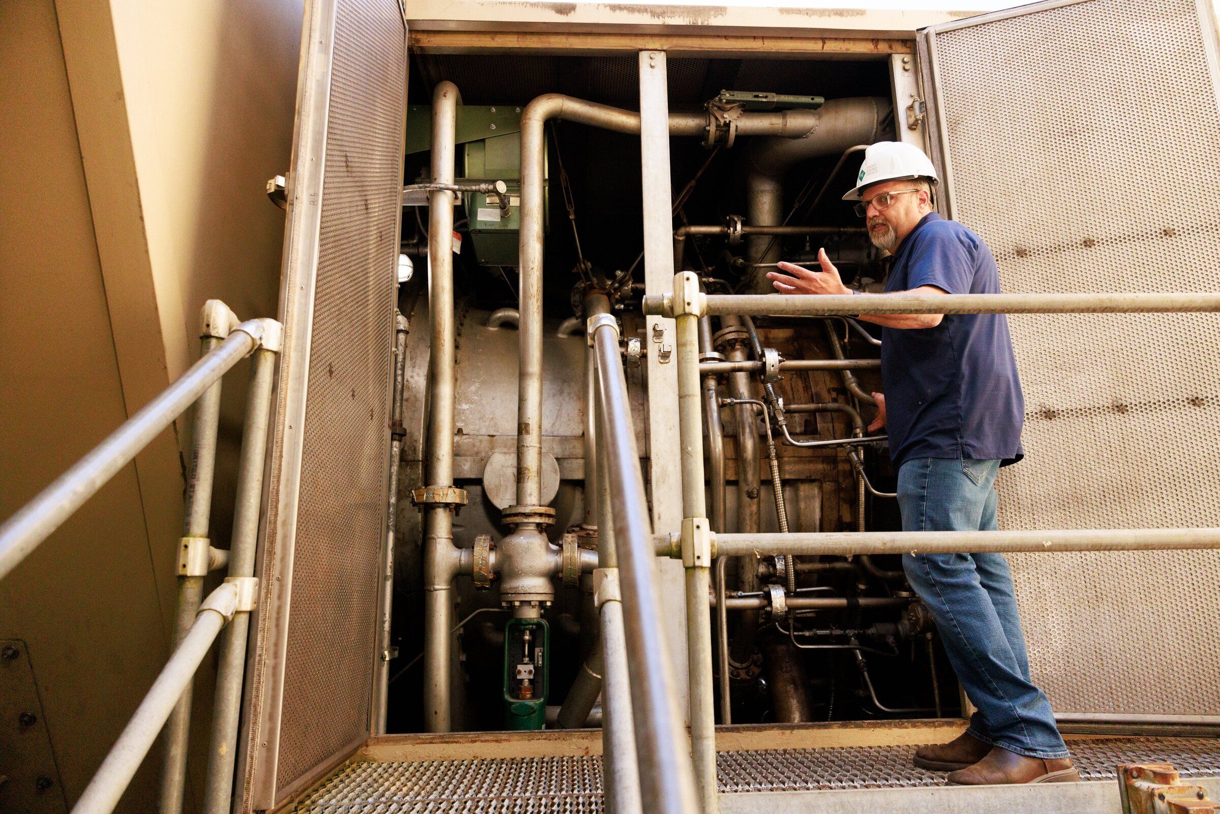 Foreman Tony Ostlund gives a tour in July of the gas turbine at the Frederickson Generation Station in Pierce County. (Erika Schultz / The Seattle Times)