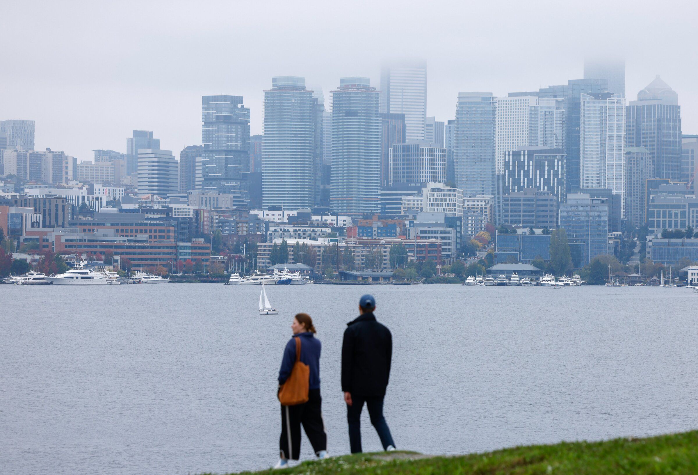 People walk through Gas Works Park, backdropped by the Seattle skyline, on Saturday. (Andrew Burke-Stevenson / The Seattle Times)