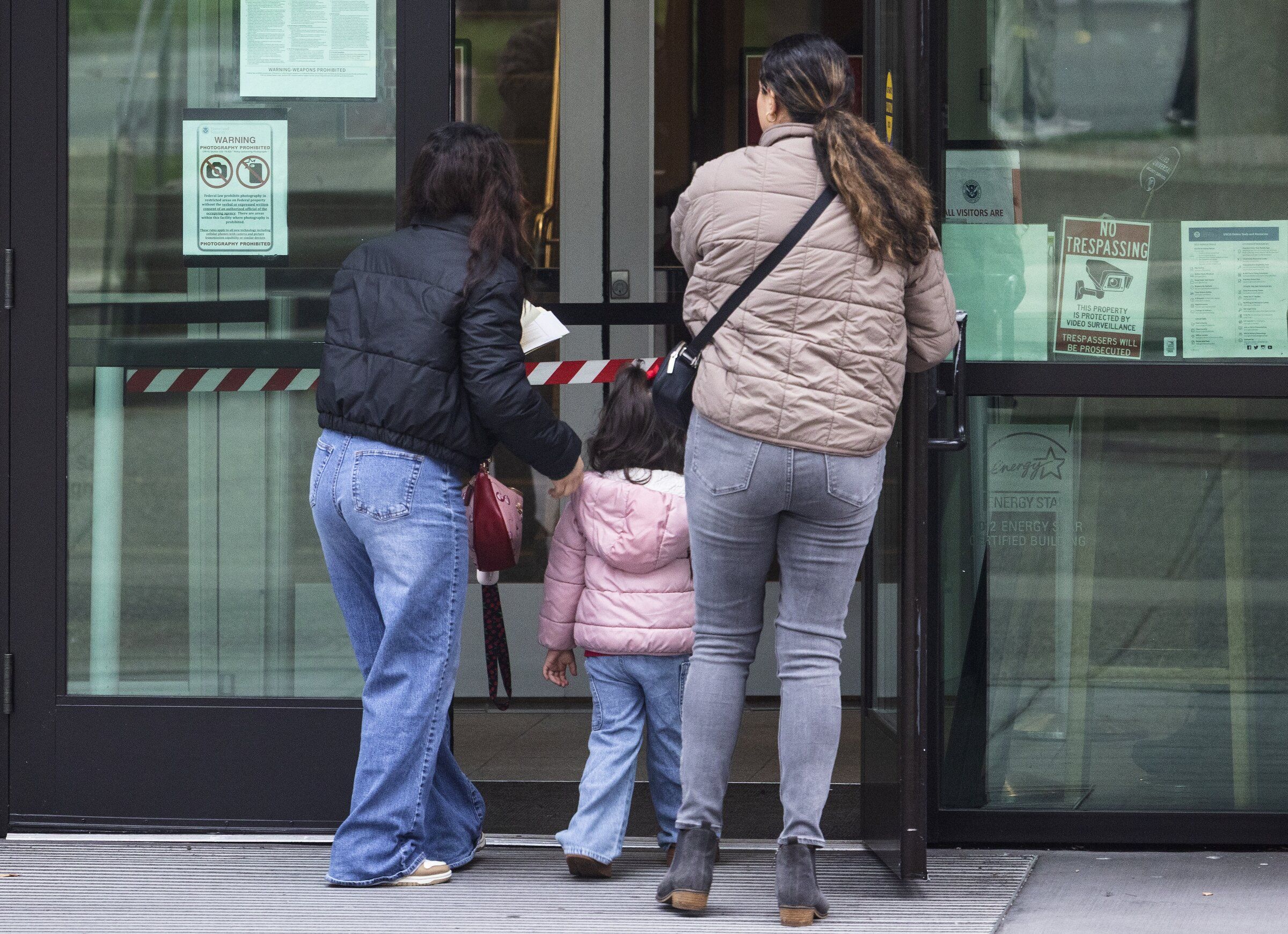 People enter the U.S. Department of Homeland Security building in Tukwila on Thursday. The building houses a local ICE office where immigrants are required to check in while their cases are being considered. (Ken Lambert / The Seattle Times)