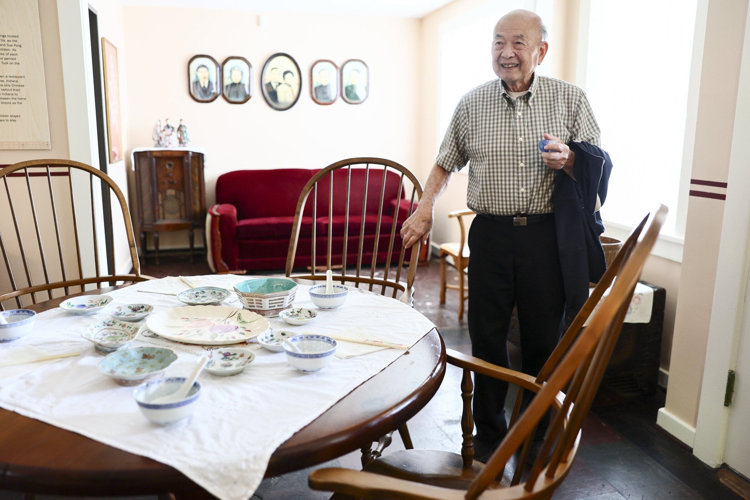 Tak Eng stands in his childhood home, which his family partially sold and donated to the Wing Luke Museum. His father, Suen King Eng, built the house in the 1930s, and three generations of the family lived there. (Kevin Clark / The Seattle Times)
