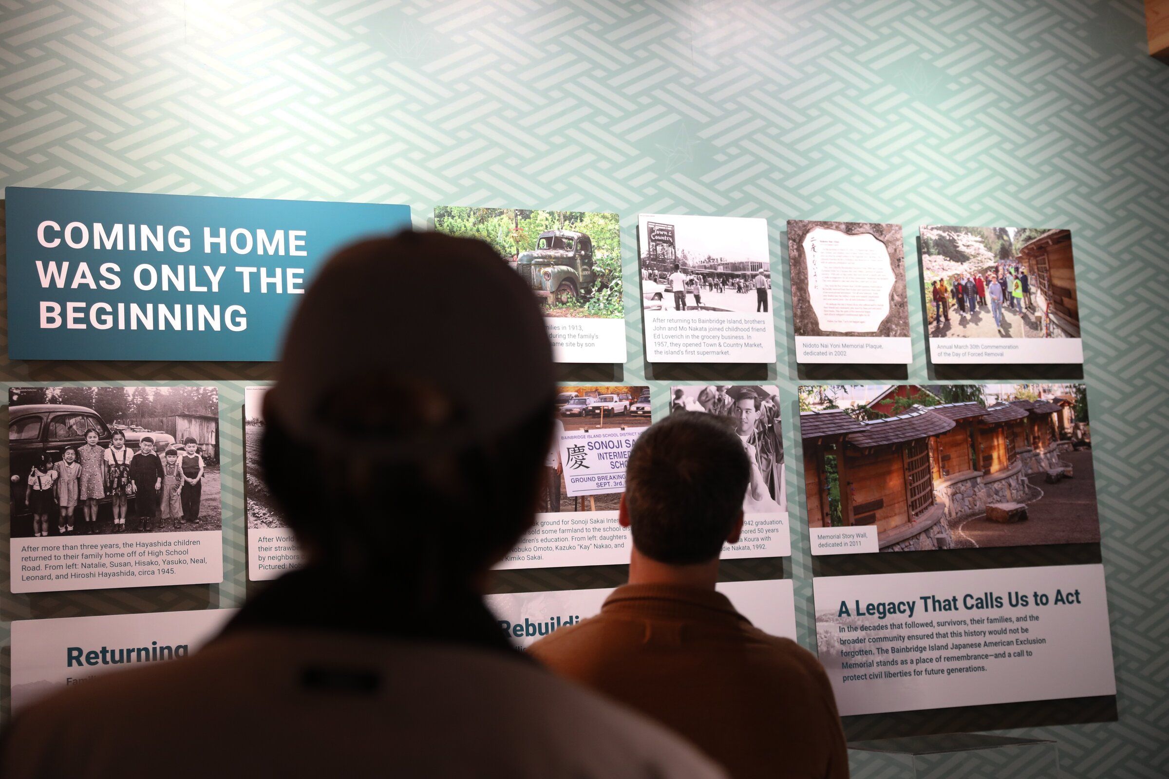 Visitors view the exhibition at the opening of the visitor center for the Japanese American Incarceration Memorial on Bainbridge Island on Sunday. (Naomi Ishikawa / The Seattle Times)