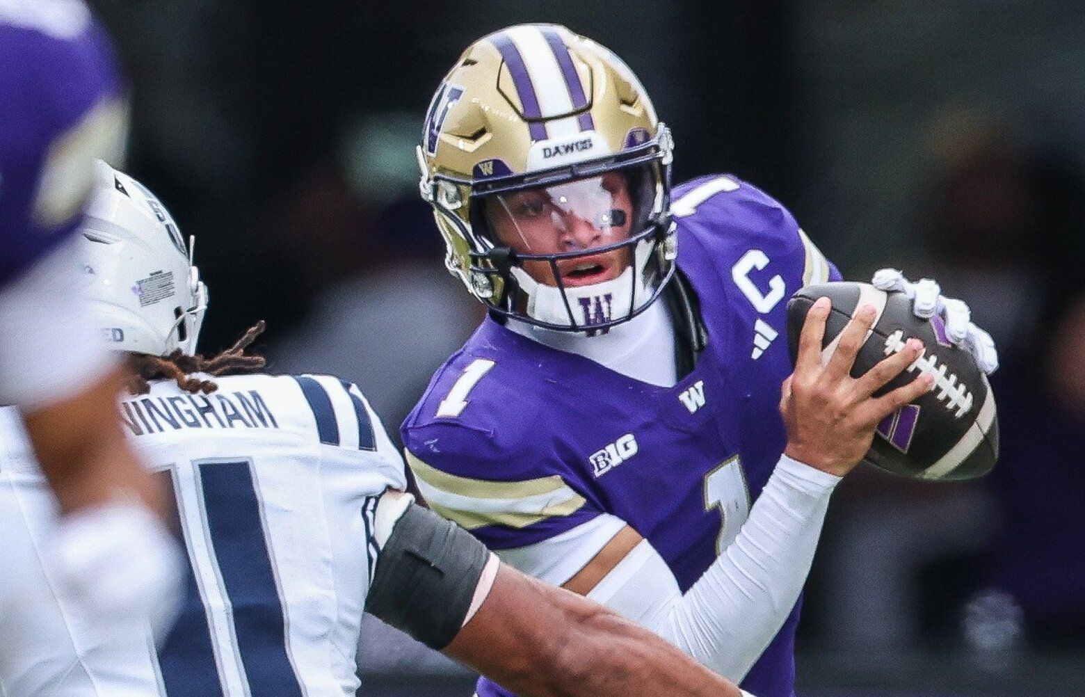 Unable to find time to pass, Demond Williams Jr. takes a seven-yard sack in the third.  The Utah State Aggies played the 19th-ranked Washington Huskies in NCAA 