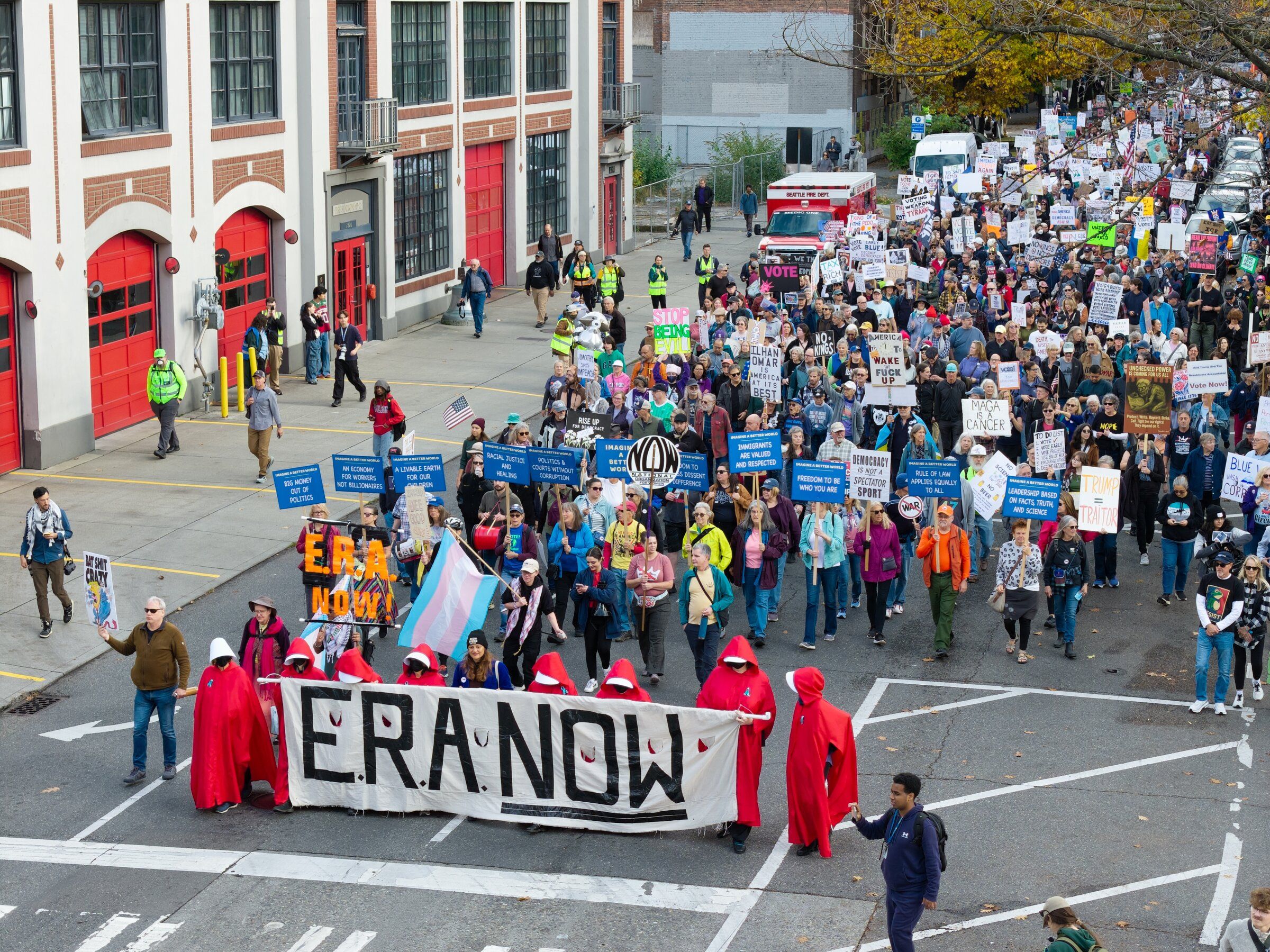 Protesters march along Fourth Avenue on Saturday carrying a large banner supporting the Equal Rights Amendment. (Karen Ducey / The Seattle Times)