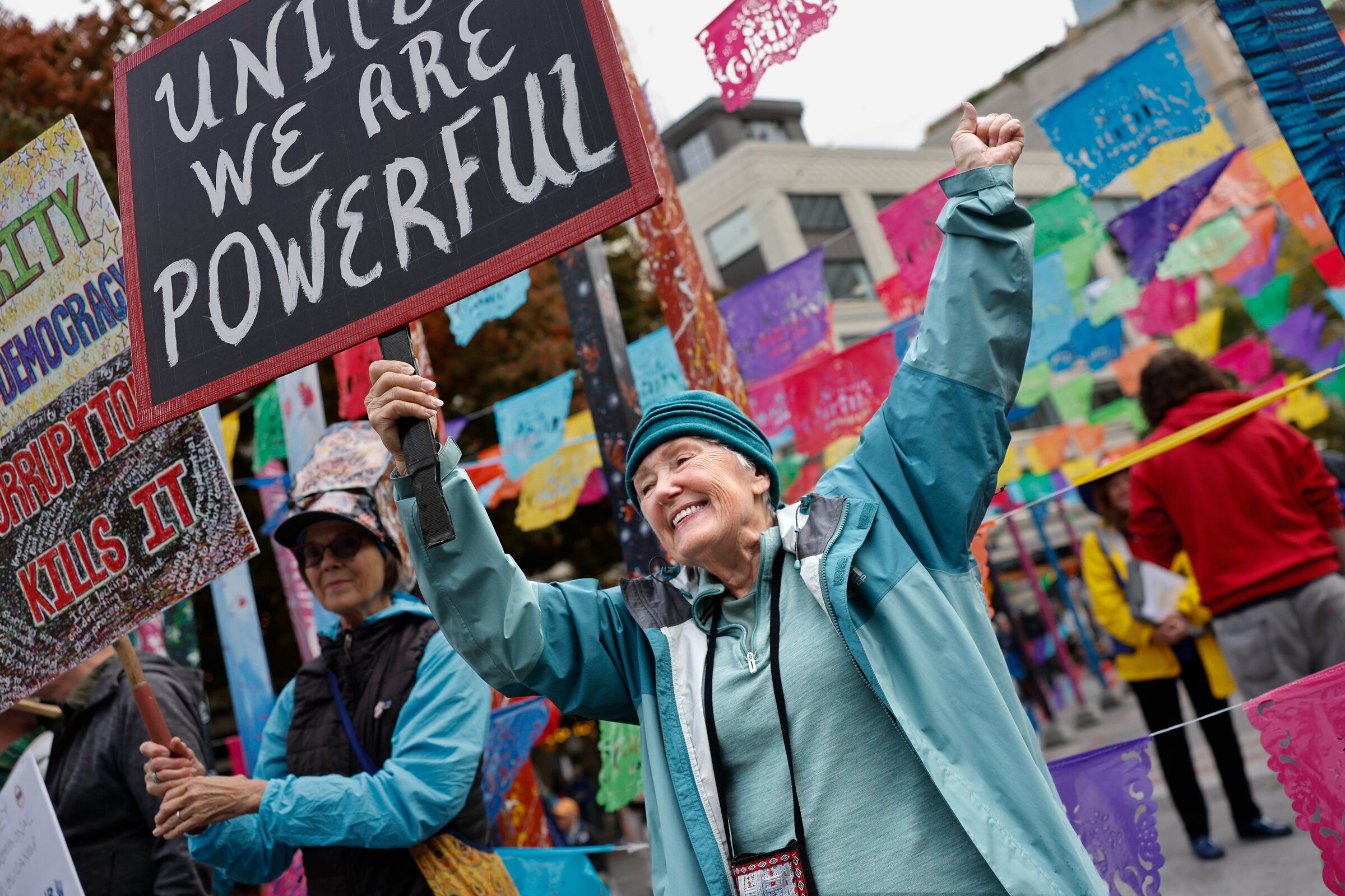 “We should be joyful as we protest,” said Anne Purcell, right, while walking with Patricia Bezzo, both from Seattle, as they participated in the No Kings rally at Westlake Park just before the start of the march to Seattle Center on Saturday. (Karen Ducey / The Seattle Times)