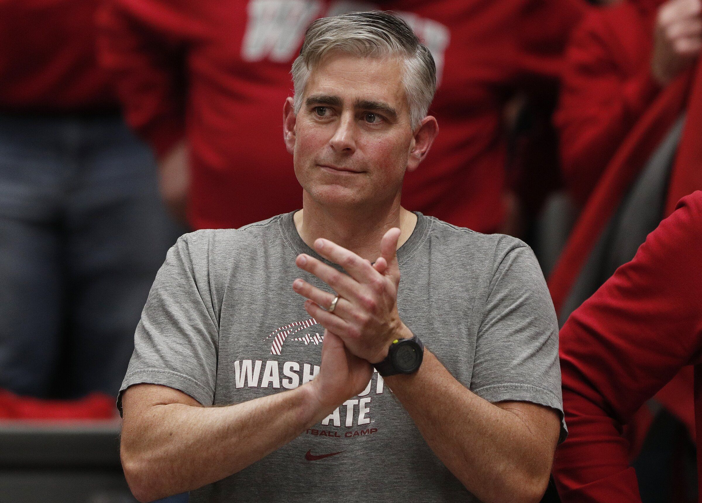Michael Baumgartner applauds after an NCAA college basketball game between Washington State University and the University of California, Los Angeles, in Pullman. (Young Kwak / Associated Press, 2024)