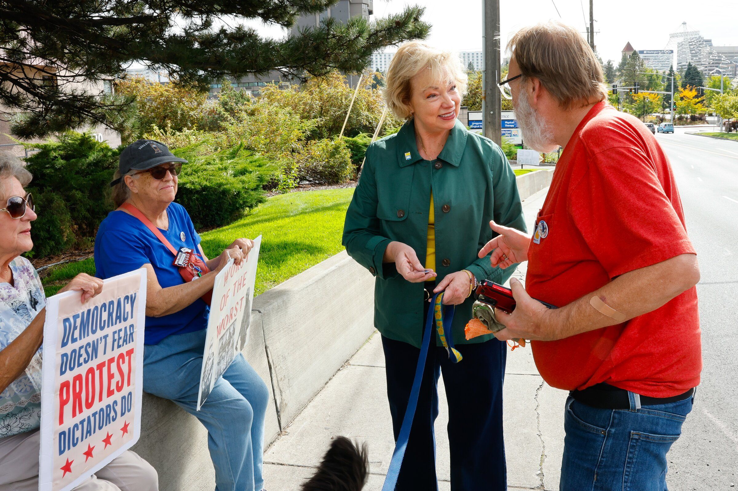 Democrat Carmela Conroy speaks with protesters against U.S. Immigration and Customs Enforcement (ICE), including Bonnie Ray (left) and Lorraine Queener, in Spokane last month. (Karen Ducey / The Seattle Times)