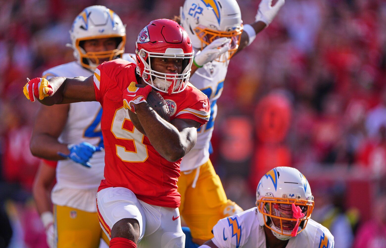 Kansas City Chiefs running back Kenneth Walker III (9) rushes for a touchdown as Los Angeles Chargers players give chase during the first half of an NFL footbal