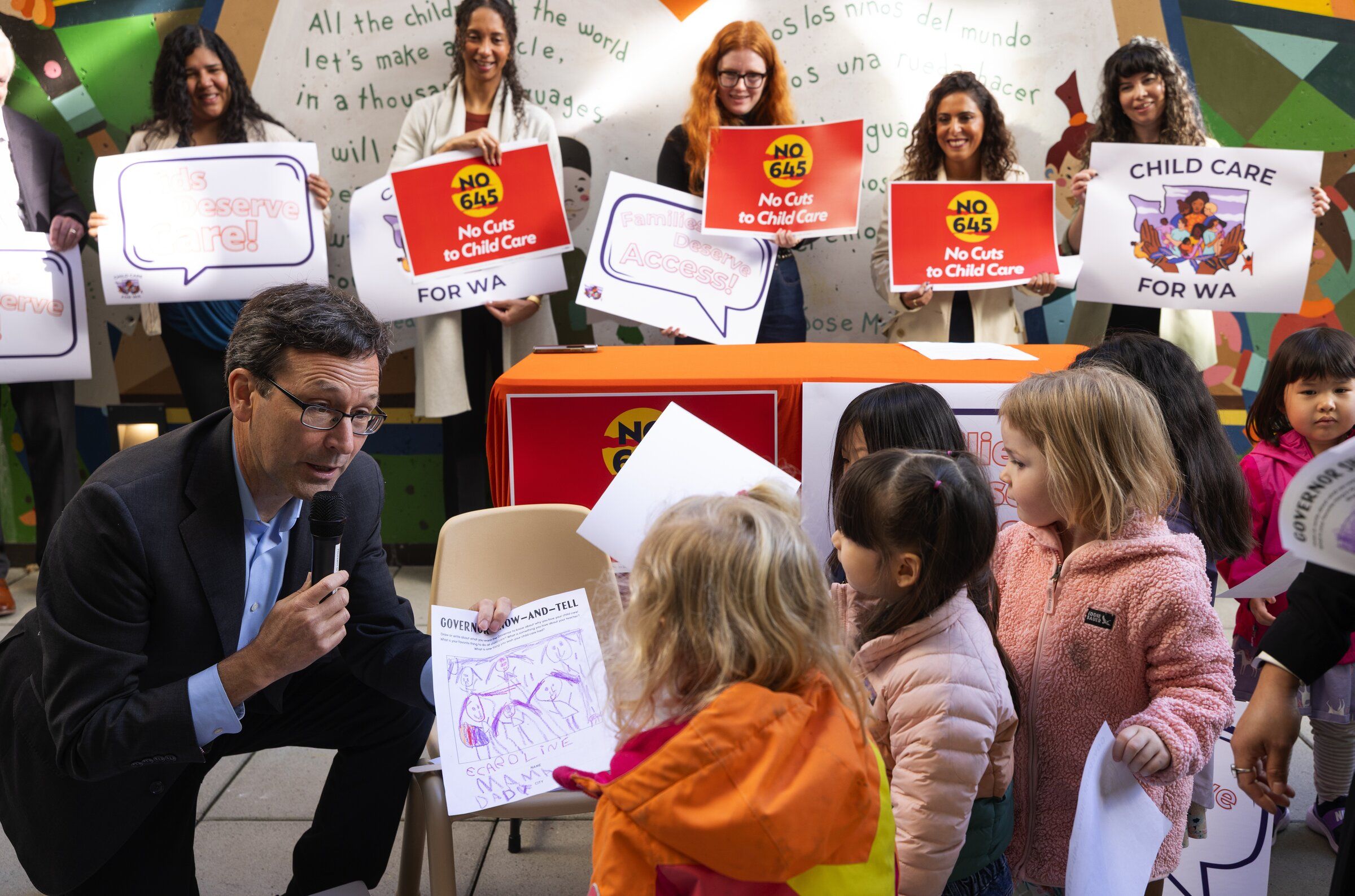 Gov. Bob Ferguson speaks to children at the José Martí Child Development Center during a news conference urging voters to vote “no” on the “millionaires tax” repeal, Tuesday, Oct. 20, in Seattle. (Ken Lambert / The Seattle Times)