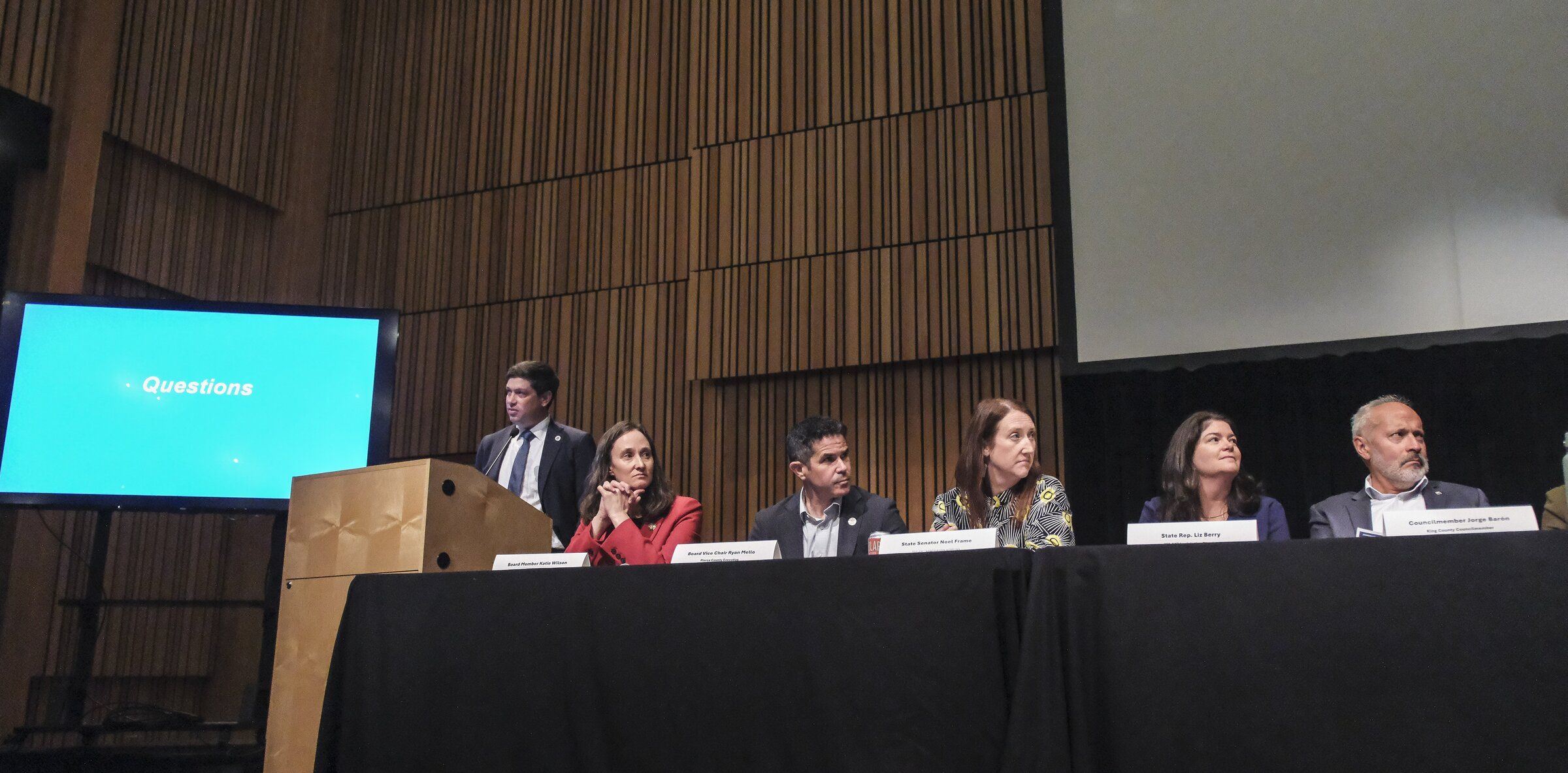 Seattle City Council member Dan Strauss (left) leads a rail-transit forum on Monday evening with other elected officials and Sound Transit leaders in Ballard. (Dean Rutz / The Seattle Times)