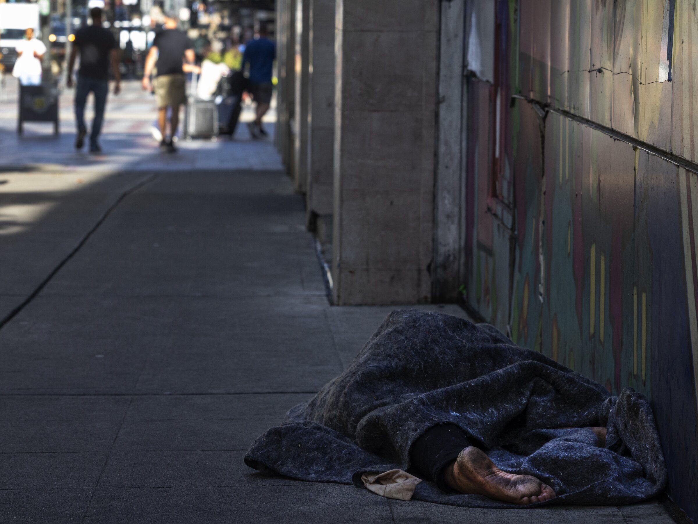 A person sleeps on Pine Street downtown on Sept. 9. (Ken Lambert / The Seattle Times)