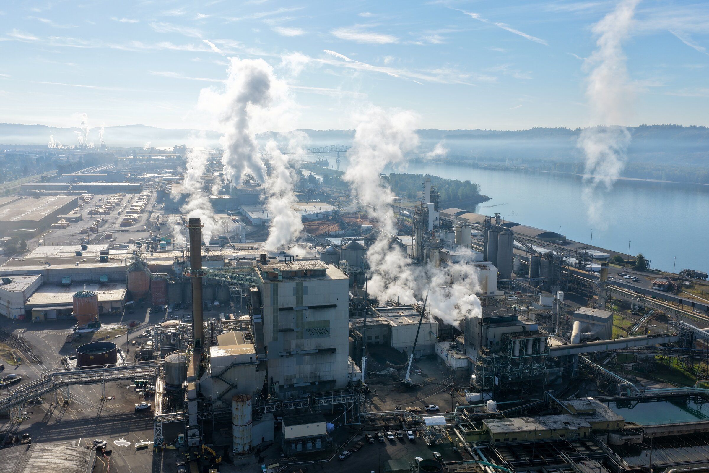 Steam rises from stacks at the Nippon Dynawave Packaging facility in Longview on Oct. 16, 2026. A chemical tank failure on May 26 left 11 workers dead. (Karen Ducey / The Seattle Times)