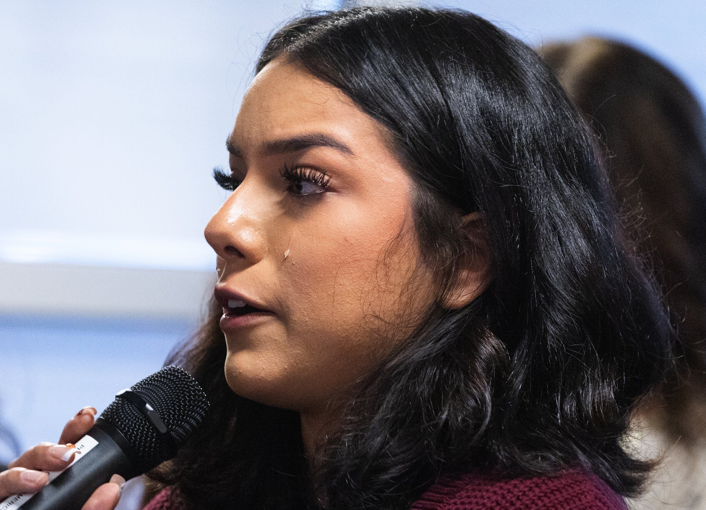 A tear rolls down Alondra Miranda Garcia’s cheek as she speaks at a press conference Tuesday about her father’s arrest by federal agents. “He is a hardworking, humble man who has spent more than 23 years building a life centered on his family,” Miranda Garcia said. (Ken Lambert / The Seattle Times)