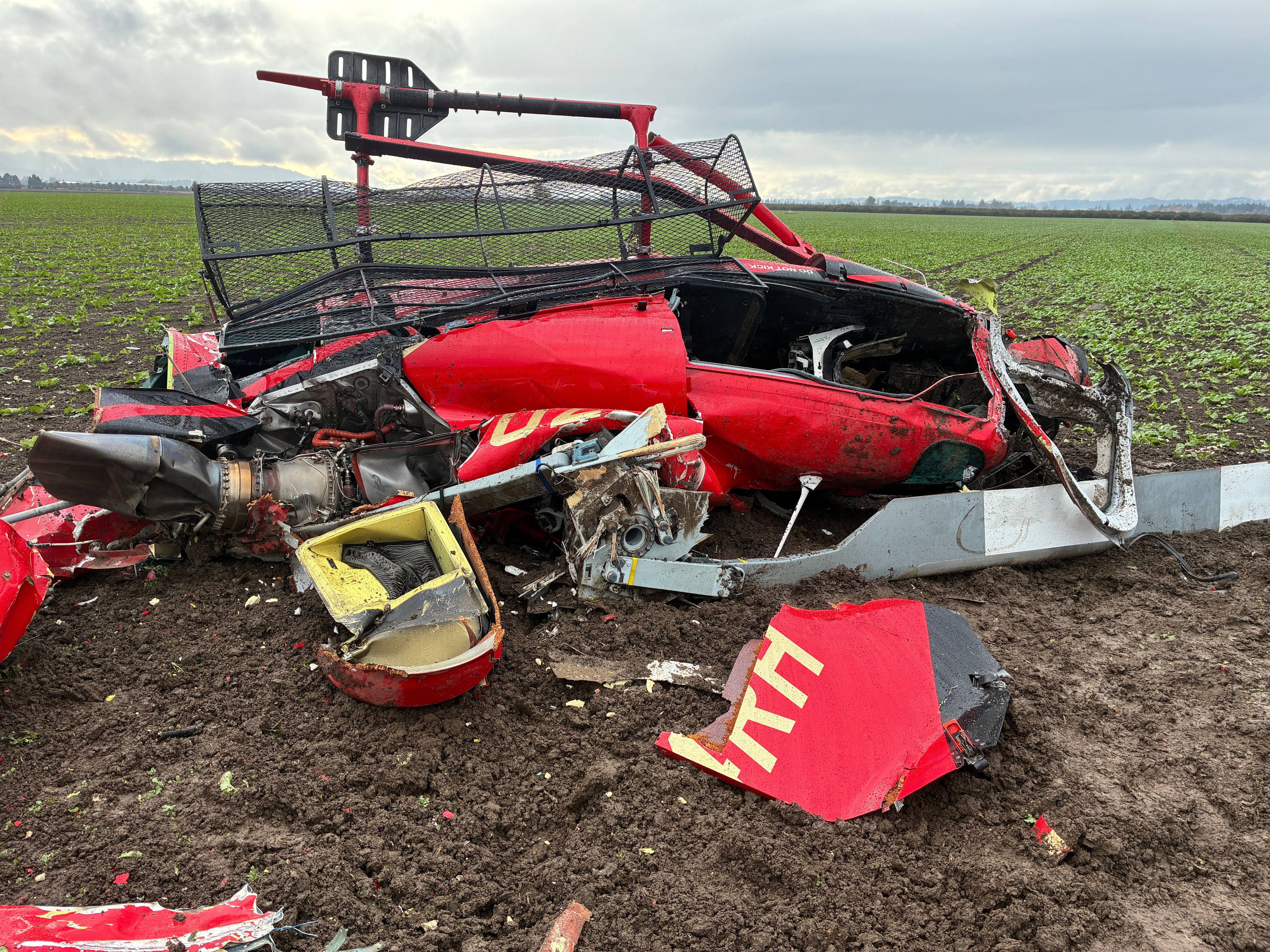A damaged helicopter after two helicopters collided and crashed into a farm field in Yamhill County, Ore., on Thursday. (Yamhill County Sheriff’s Office via AP)